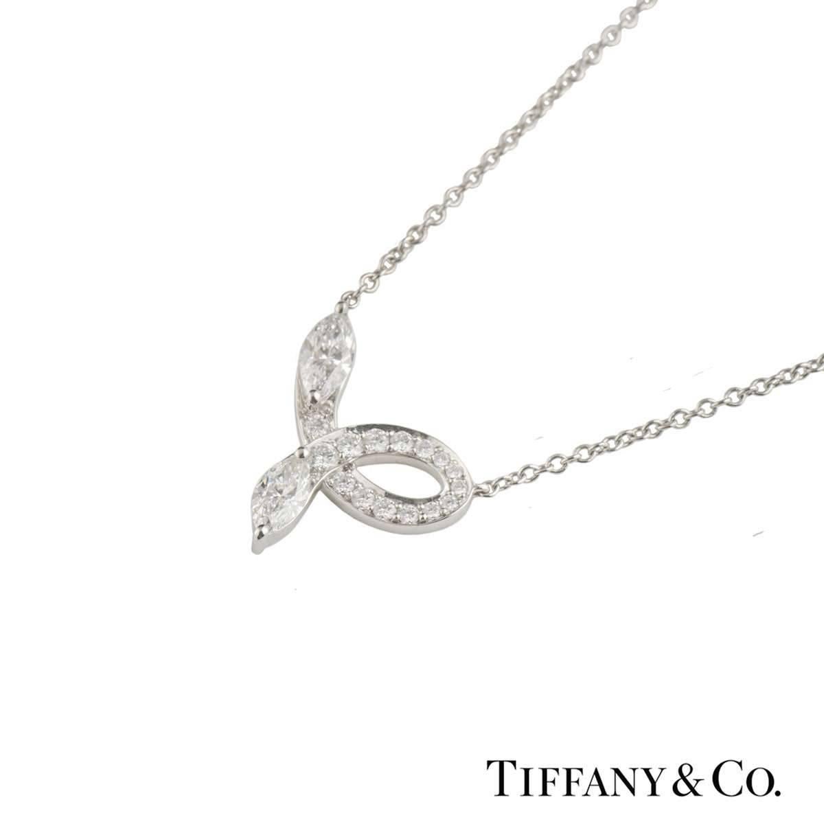 A beautiful platinum Tiffany & Co. diamond pendant from the Victoria collection. The pendant comprises of an open work bow design with 2 marquise cut diamonds at each end with a total weight of 0.46ct, G-J colour and IF-SI1 clarity.