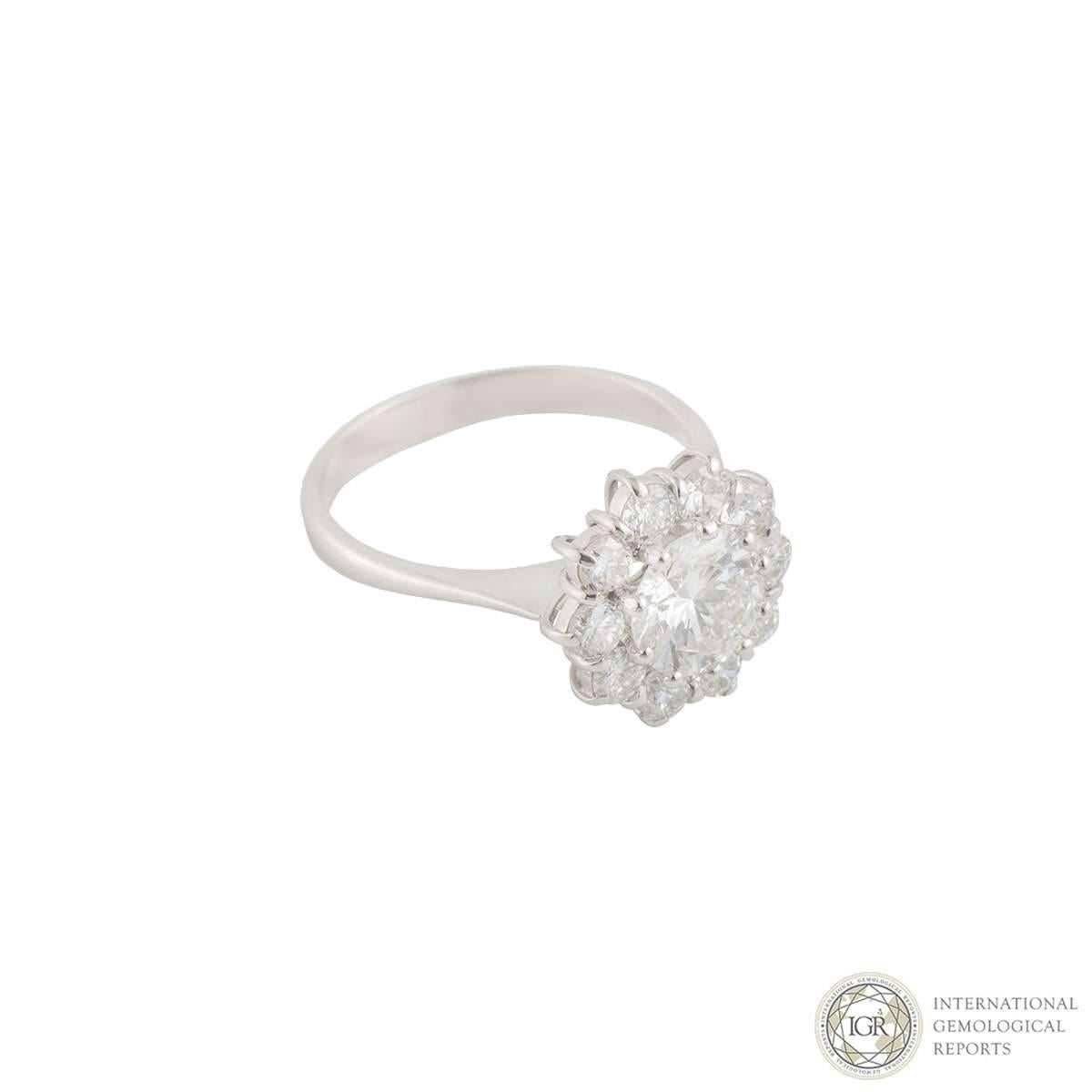 A beautiful 18k white gold diamond ring. The ring is set to the centre with a 1.29ct round brilliant cut diamond, E colour and VS2 clarity. Surrounding the diamond is a halo of 10 round brilliant cut claw set diamonds totalling approximately 0.80ct,