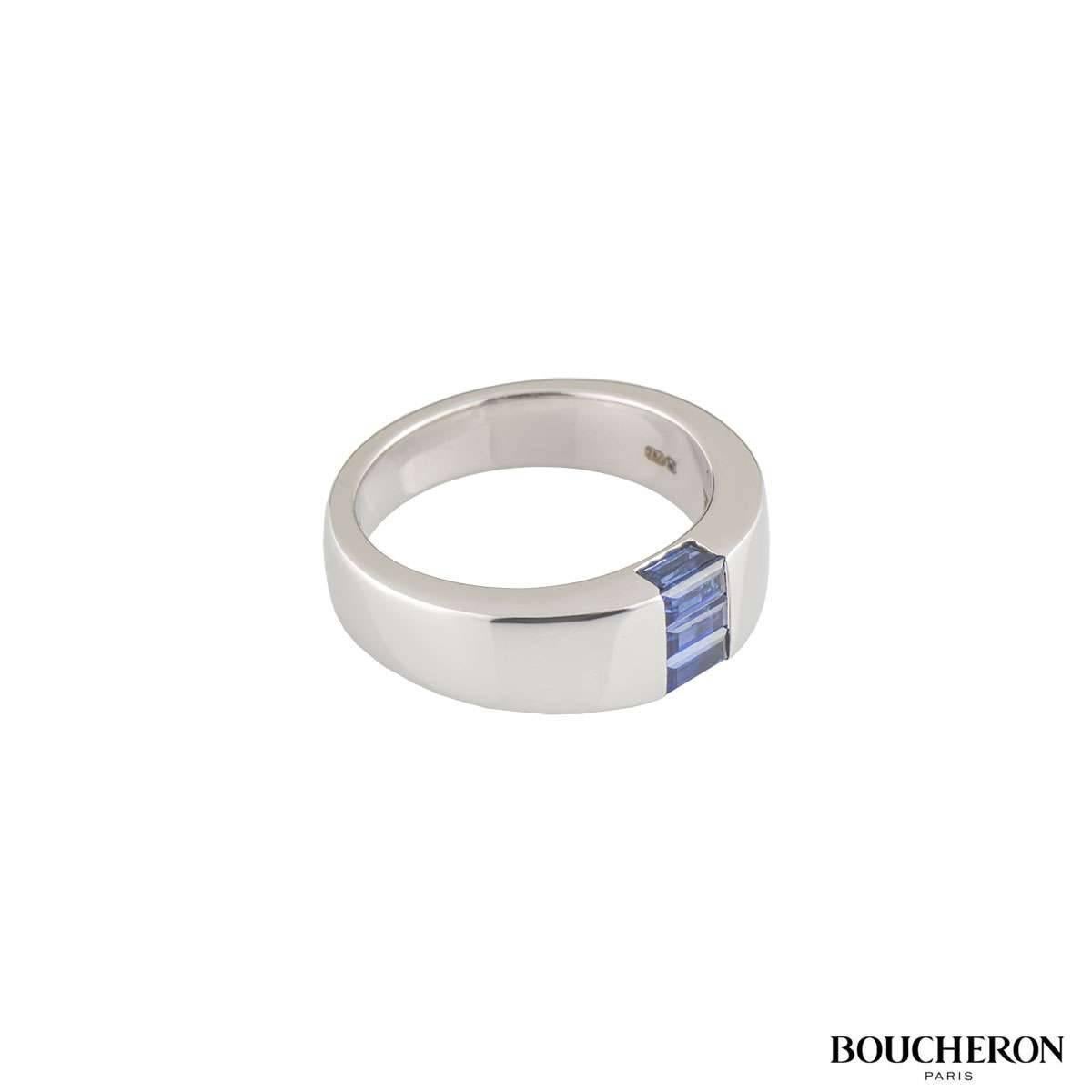 An 18k white gold sapphire ring from the Malice collection by Boucheron. The ring is set to the front with 5 baguette cut sapphires in a tension setting with a total weight of 0.80ct, displaying a deep blue hue. The ring measures 6.7mm at the front