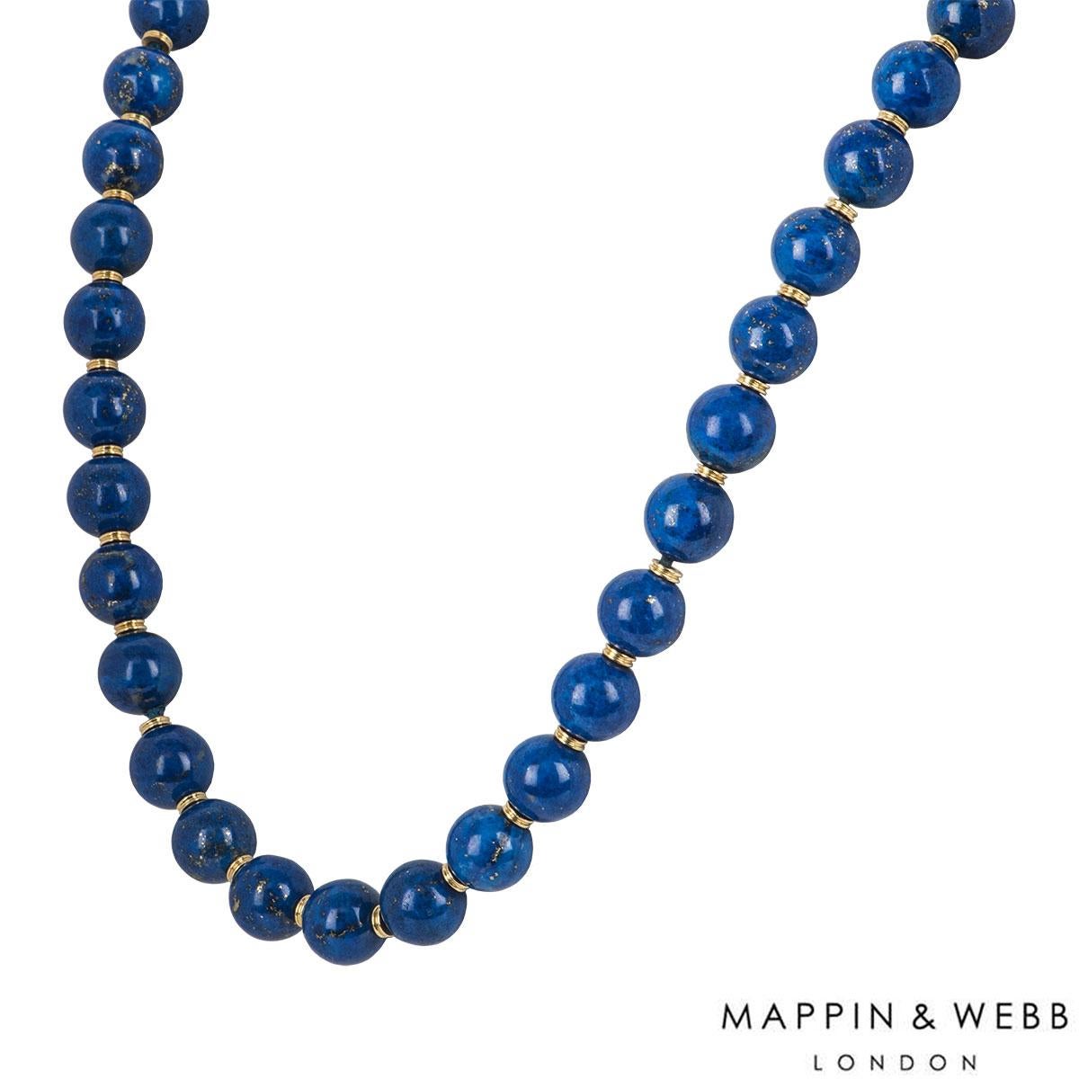 An 18k yellow gold 46 lapis ball set necklace by Mappin & Webb. The necklace comprises of 46 lapis balls with yellow gold barrels in between each ball all joined together by a rope. The necklace has a length of 15.50 inches and a gross weight of 301