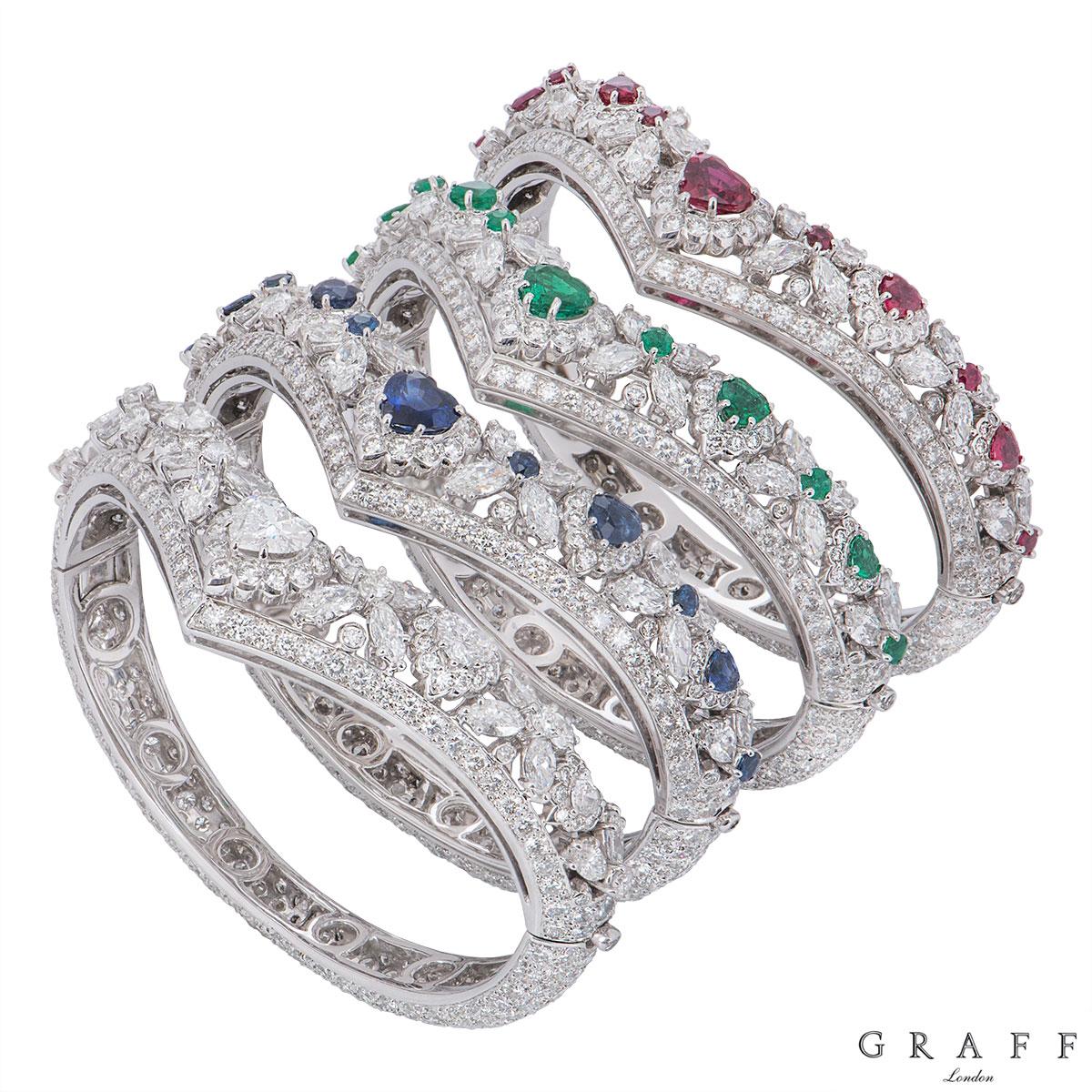 A truly unique and striking set of 4 diamond and gem set bangles in 18k white gold by Graff.

The first bangle - 18k white gold set with diamonds and rubies to the front v shape motif. The bangle features 5 heart cut rubies, separated by marquise