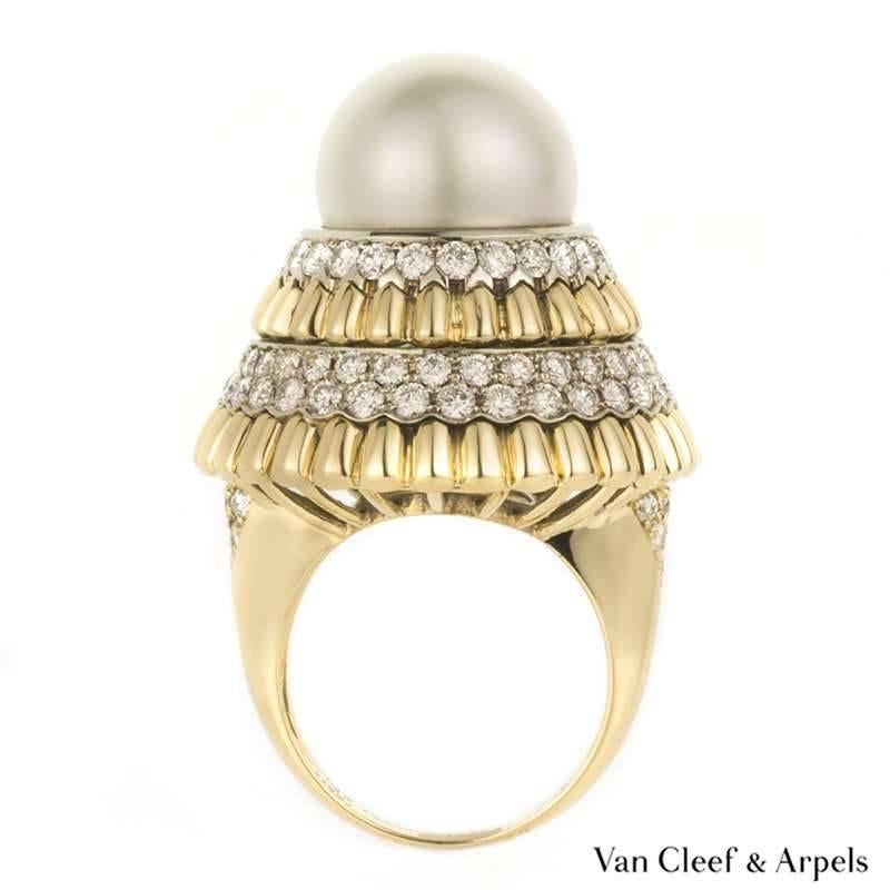 An amazing 18k yellow gold Wedding Cake ring by Van Cleef & Arpels from the 1970's. The ring is circulated with alternating layers of pave set diamonds and yellow gold 'icing'. A large cultured pearl sits in the centre of the ring and measures