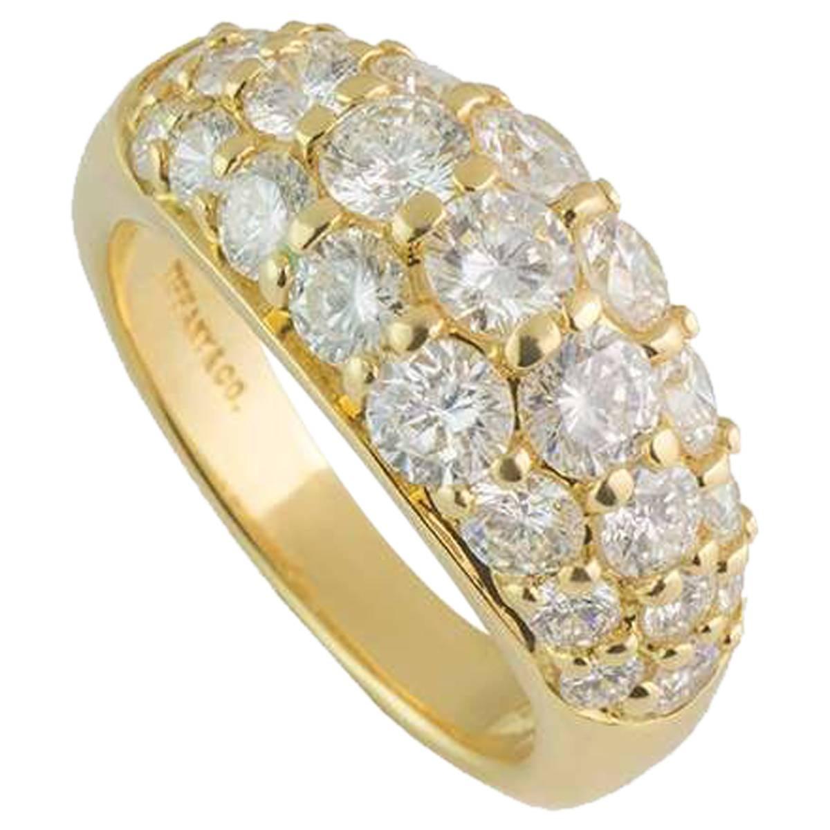 A stunning 18k yellow gold diamond set bombe style half eternity ring by Tiffany & Co. The ring is set to the centre with three rows of graduating round brilliant cut diamonds, each individually claw set, totalling approximately 2.20ct,