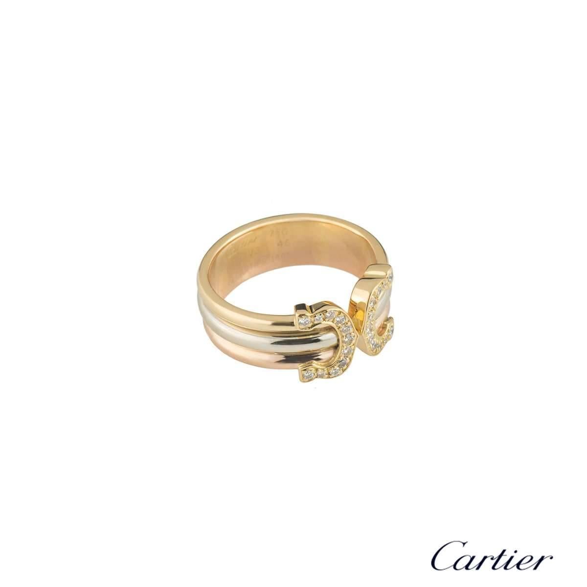 A unique 18k tri-colour gold ring from the Ce de Cartier collection by Cartier. This ring comprises of an open design with an iconic C motif at each end. Each motif is set with 11 round brilliant cut diamonds graduating in size in a pave setting,