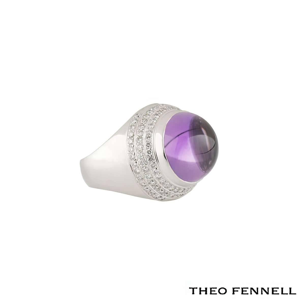 A fashionable 18k white gold dress ring by Theo Fennell. The dome shaped ring is set to the centre with a cabochon cut amethyst weighing approximately 12.00ct complimented by 3 circular rows of round brilliant cut diamonds totalling approximately