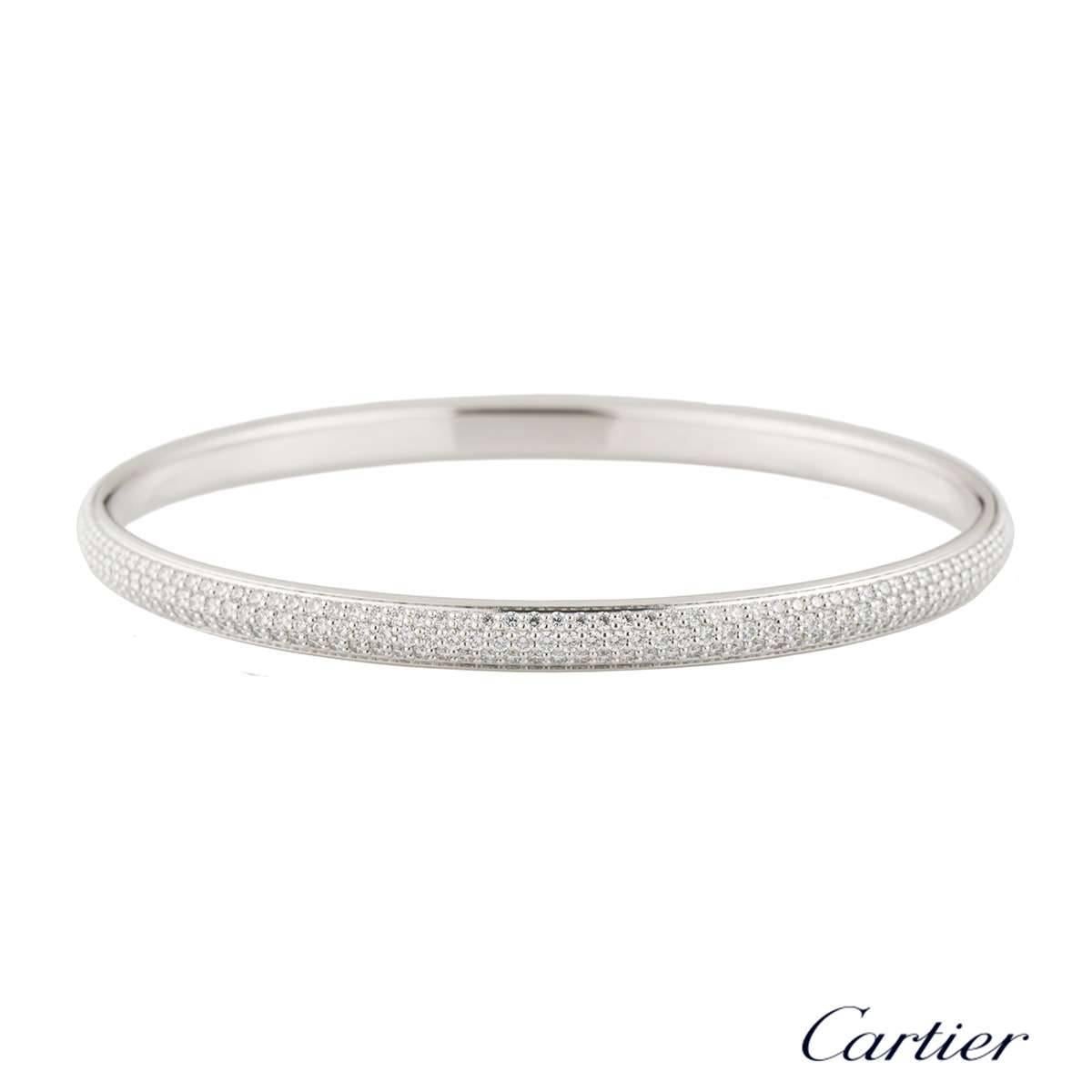 A stunning diamond set bangle by Cartier. The bangle is set with 3 rows of round brilliant cut claw set diamonds totalling approximately 4.05ct. The diamonds are predominantly F colour and VS+ clarity. The bangle is 5mm in width and would fit a