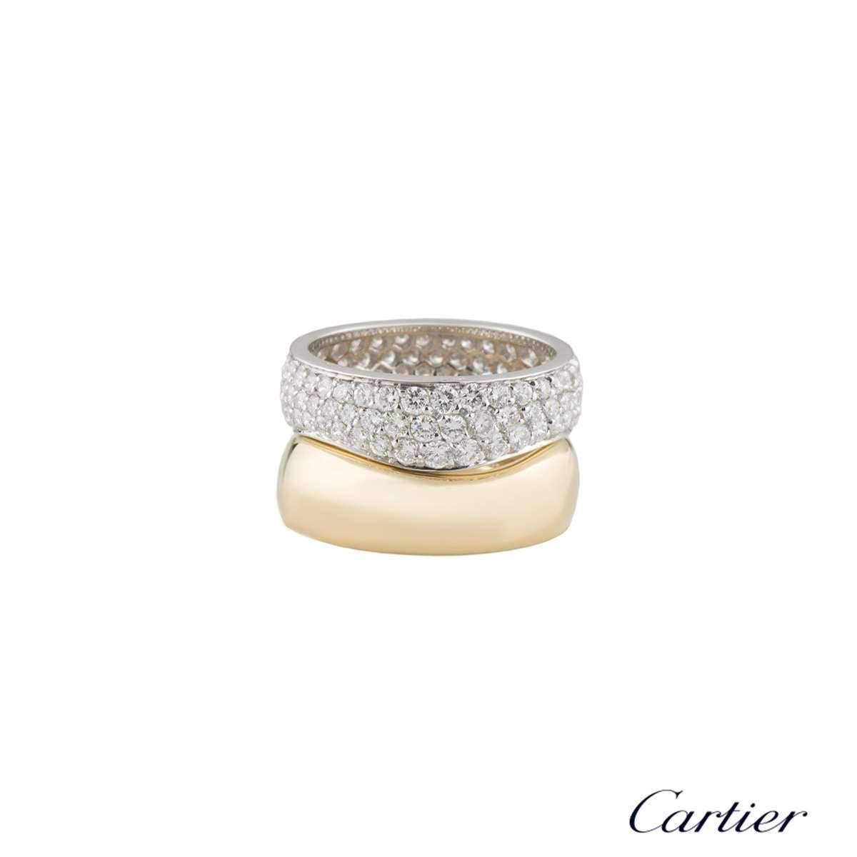 A beautiful 18k white and yellow gold double stacker ring by Cartier. The ring is composed of 2 waved bands. One band is pave set with 102 round brilliant cut diamonds totalling approximately 1.73ct, predominantly F in colour and VS-VVS in clarity.