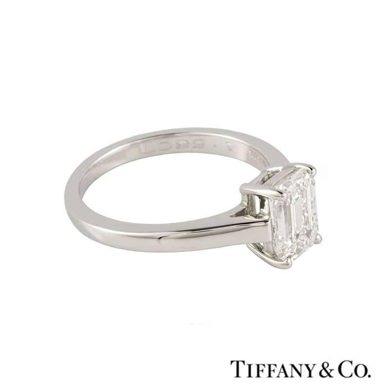 A stunning emerald cut diamond single stone ring in platinum by Tiffany & Co. The ring is set to the centre with a 1.56ct emerald cut diamond, F in colour and VS1 in clarity, set within a four claw setting. The 2mm ring is currently a UK size L, US