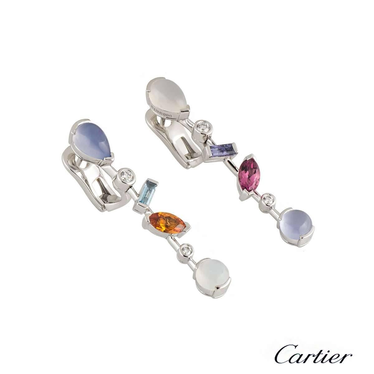 A beautiful pair of earrings in platinum from the Cartier Meli Melo collection. The earrings consist of varying cuts of diamonds, aquamarine, chalcedony, garnet, iolite, pink tourmaline and moonstone set onto a knife edge horizontal bar. The