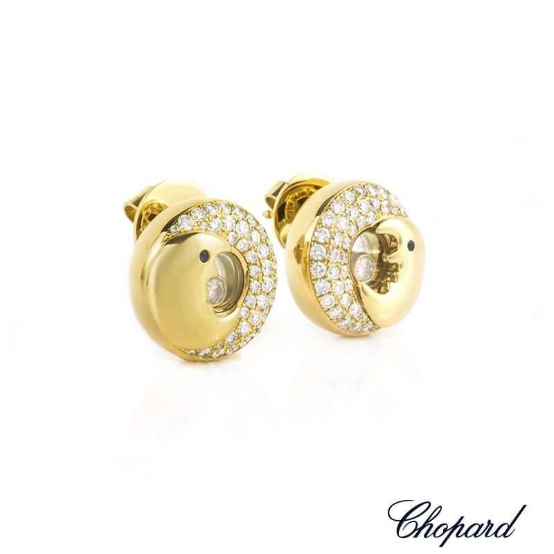 A pair of 18k yellow gold Happy Diamonds earrings by Chopard. Each earring is composed of a moon design and is set with 40 round brilliant cut diamonds weighing approximately 0.40ct in the larger moon and 1 floating diamond weighing 0.05ct set