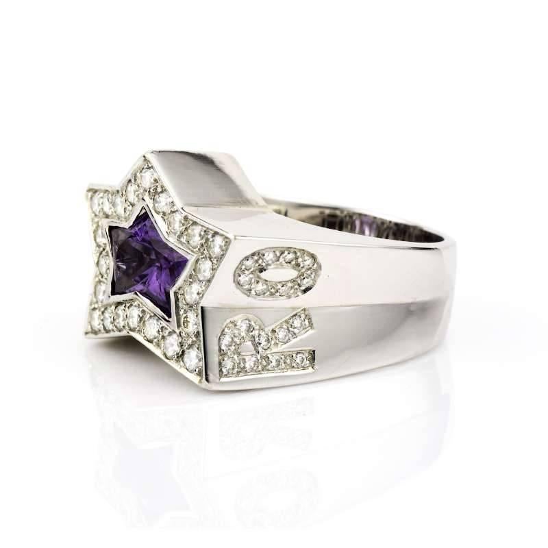 18k White Gold Amethyst and Diamond Rock Star Ring Set with a Star Shaped Amethyst and Round Brilliant Cut Diamonds Spelling Rock Star. The ring is a US size 9 1/4, EU size 60 and UK size S. Total Diamond Weight 0.25cts, H/I Colour, VS Clarity.