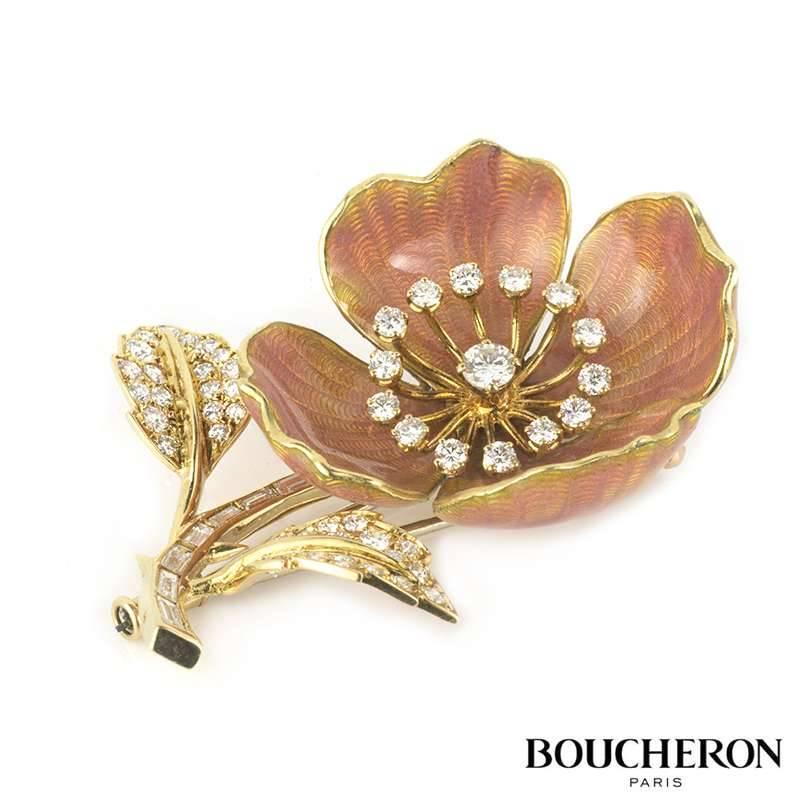 A diamond and enamel Eglantine brooch by Boucheron c.1960. Set in 18k yellow gold and platinum the brooch is designed as an open bloom with diamond set stamen within pale pink guilloche enamel petals. The stem of the flower is set with baguette cut