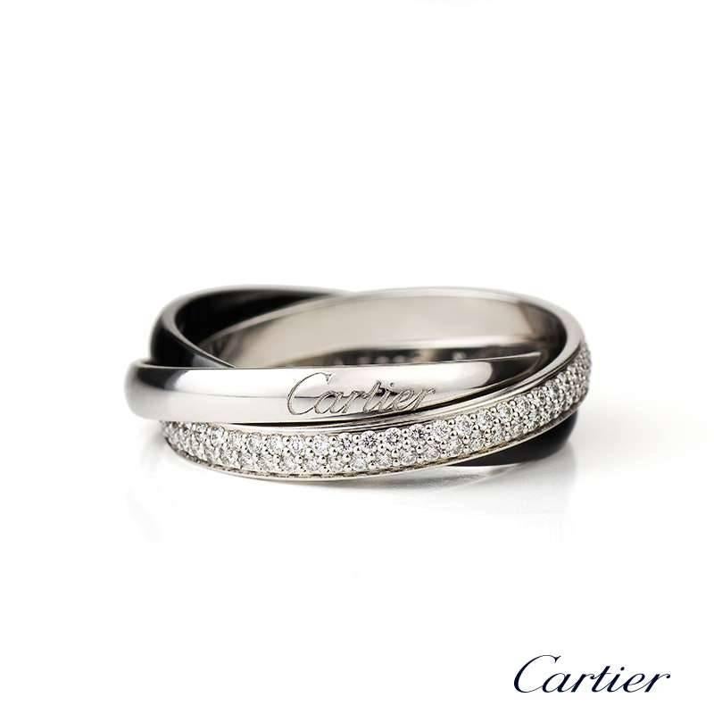 A Trinity de Cartier ring in 18k white gold and ceramic with a diamond pave set band. The ring is a US size 9 1/5, EU 61.  Cartier Model No. B4095500

The ring comes complete with original Cartier papers dated 06/04/2013 and original Cartier box.
