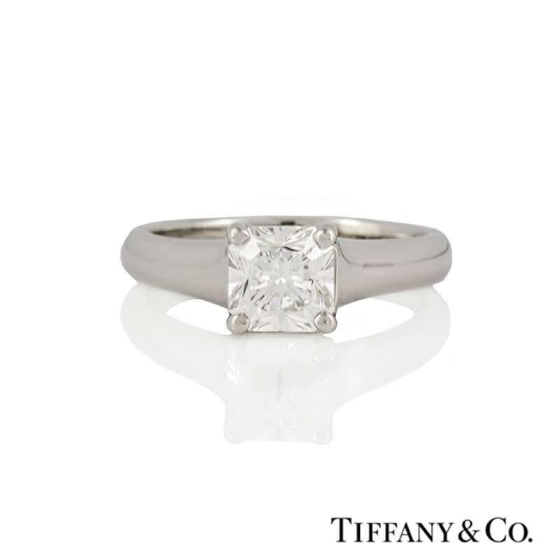 A stunning diamond ring in platinum by Tiffany & Co. The ring is set to the centre with a Lucida cut diamond weighing 1.00ct, F in colour and VVS1 in clarity set within a classic four claw setting. The 3mm tapered ring is currently a UK size J, US 4