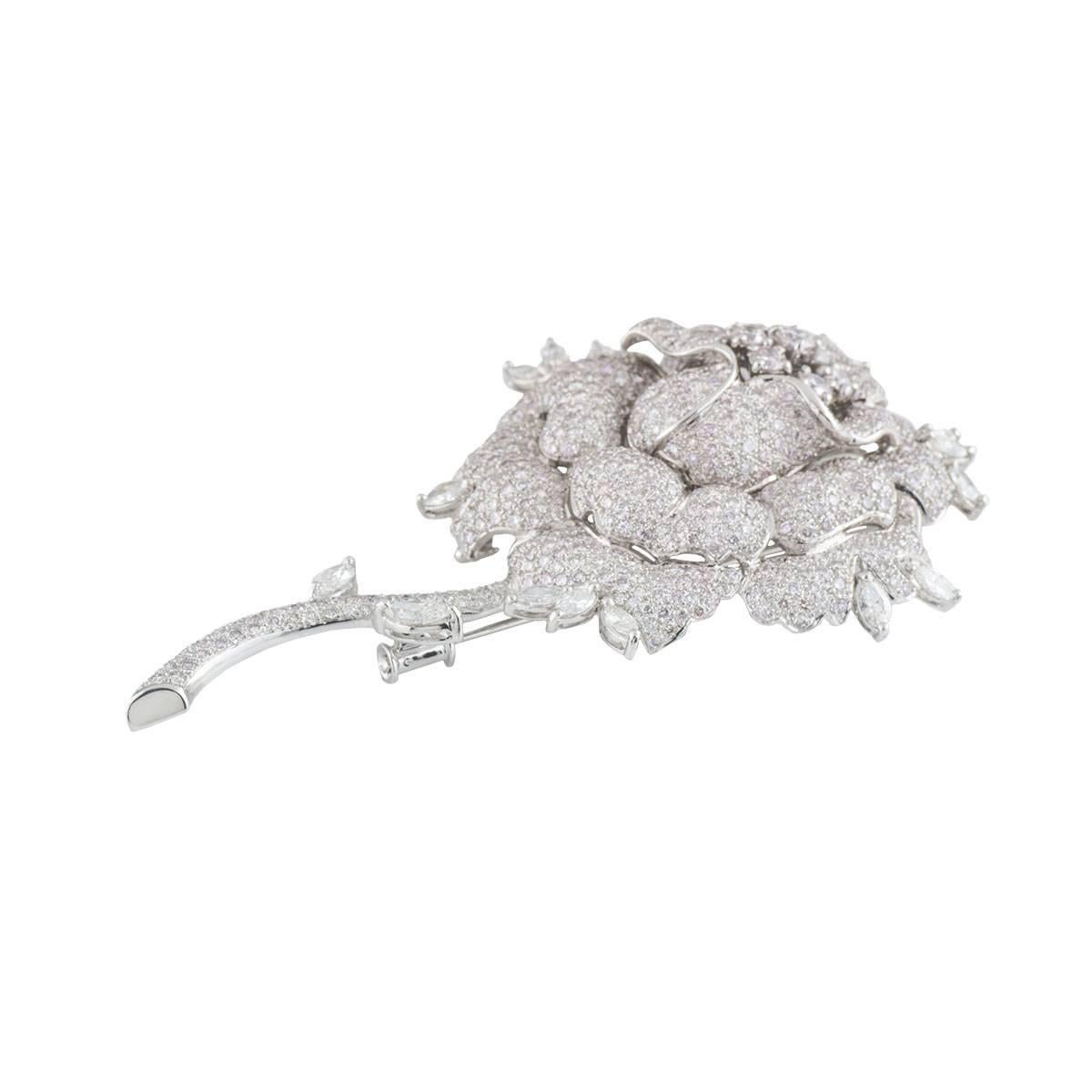 A sparkly and significant 18k white gold diamond brooch. The brooch comprises of a rose flower motif encrusted with approximately 724 round brilliant and marquise cut diamonds. The diamonds have a total approximate weight of 11.21ct, G colour and VS