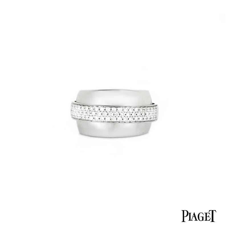 An 18k white gold diamond set Possession ring by Piaget. The 13mm wide ring has a 4mm band circulating the outer edge which is set to the front with 65 diamonds. The round brilliant cut pave set diamonds have a total diamond weight of 0.65ct. The