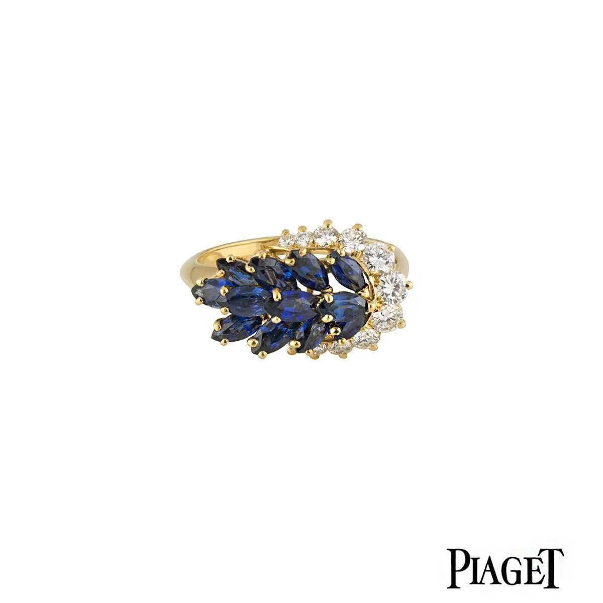 A stylish 18k yellow gold Piaget diamond and sapphire ring. The ring comprises of 12 marquise cut sapphires with in a claw setting complimented by 11 round brilliant cut diamonds graduating around one size of the ring. The sapphires have a total