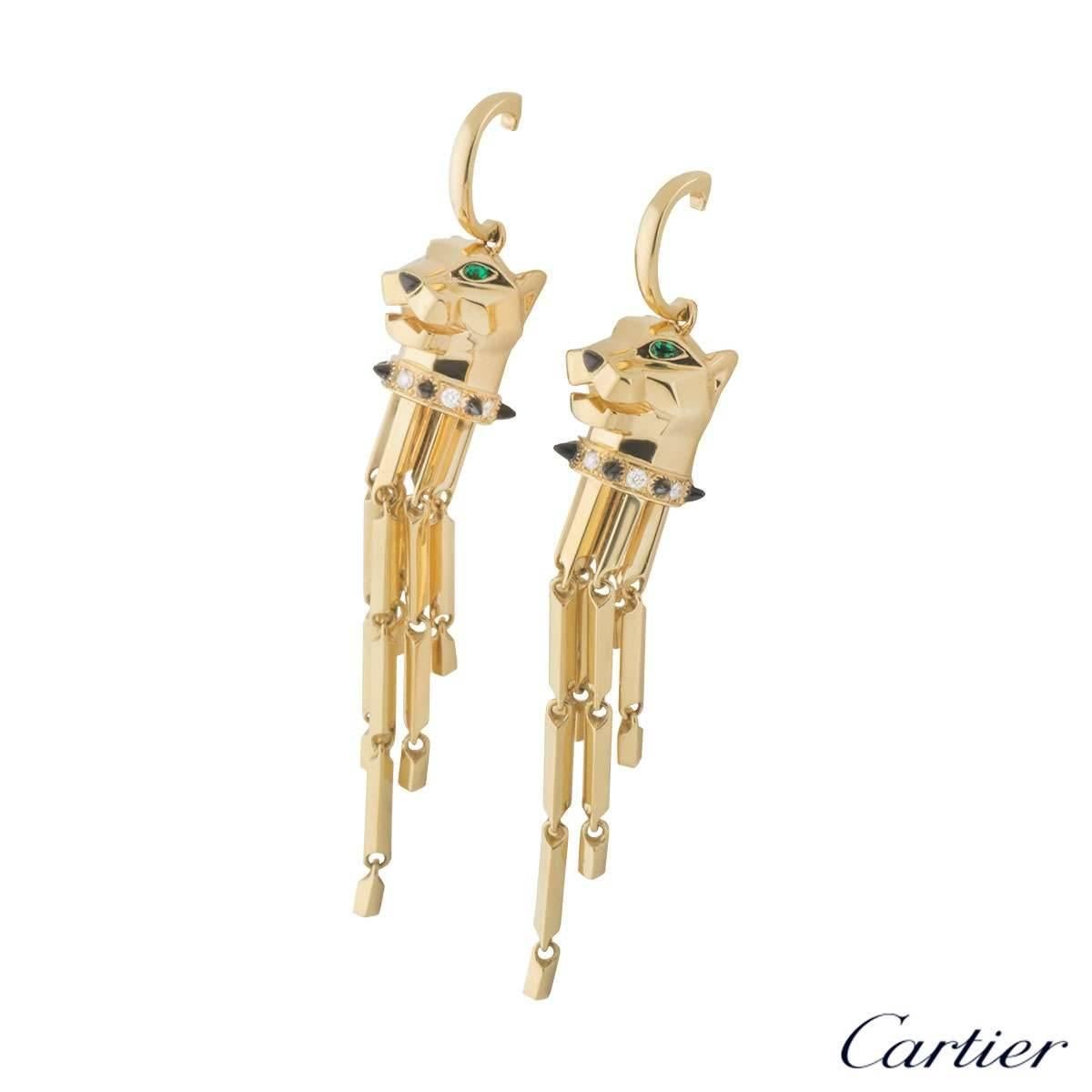 A spectacular pair of 18k yellow gold Cartier earrings from the Panthere de Cartier collection. The earrings comprise of a Panthere's head, with tsavorite set to the eyes and black onyx to the nose, complimented with black lacquer detailing. The