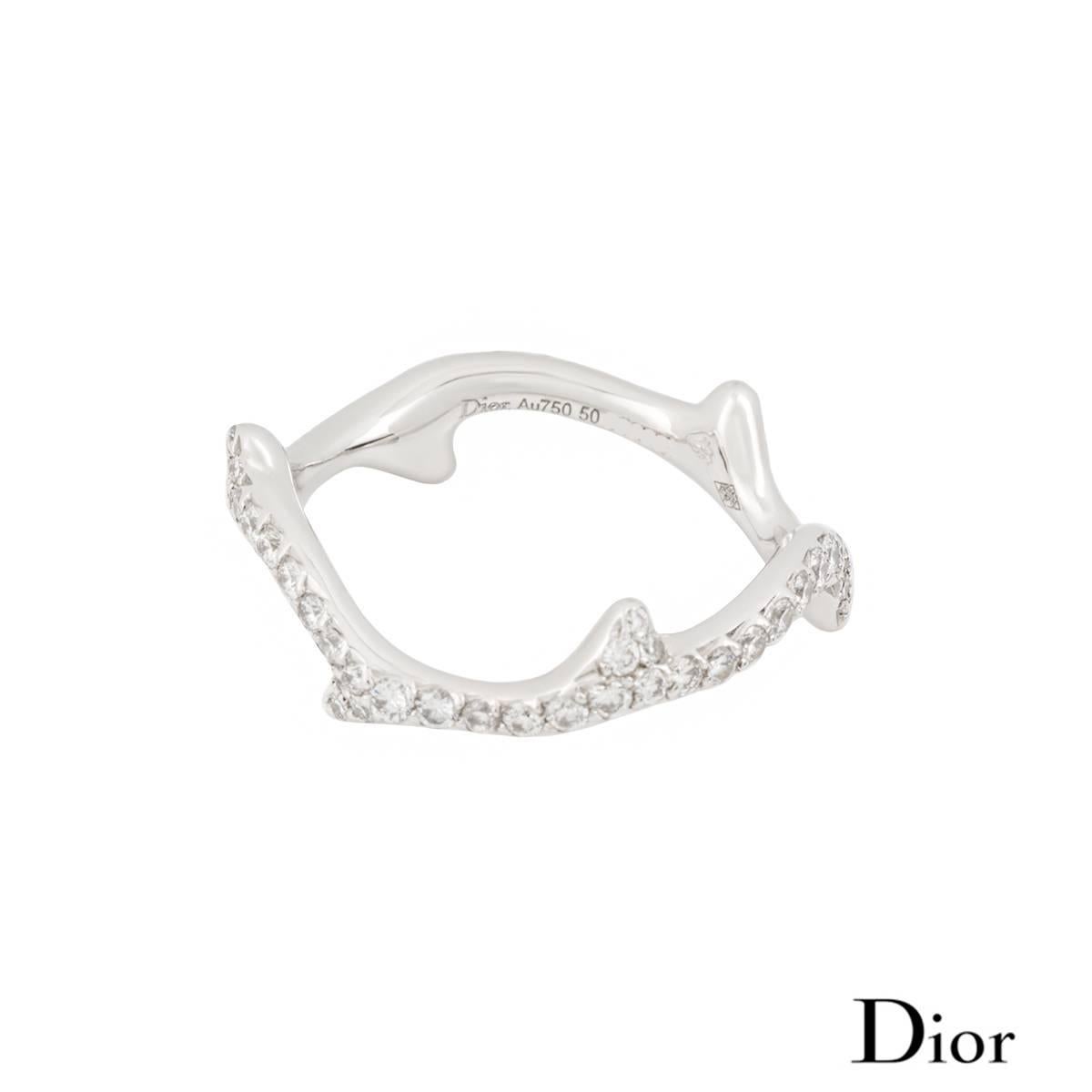 An 18k white gold diamond set Bois de Rose ring by Dior. The ring is of a rose stem design, pave set with round brilliant cut diamond totalling approximately 0.58ct. The ring measures 1.5cm in width and is a US size 5 1/2, EU size 50 and UK size K
