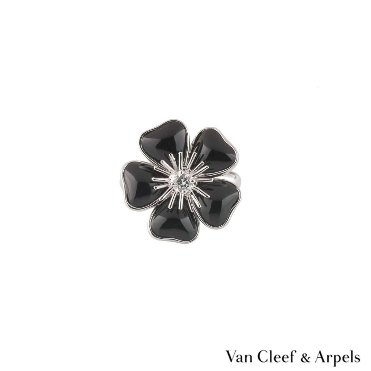 A lovely 18k white gold diamond and onyx Van Cleef & Arpels ring from the Nerval collection. The ring comprises of a flower motif with onyx placed in each petal. The center of the flower has a round brilliant cut diamond in a claw setting, with a