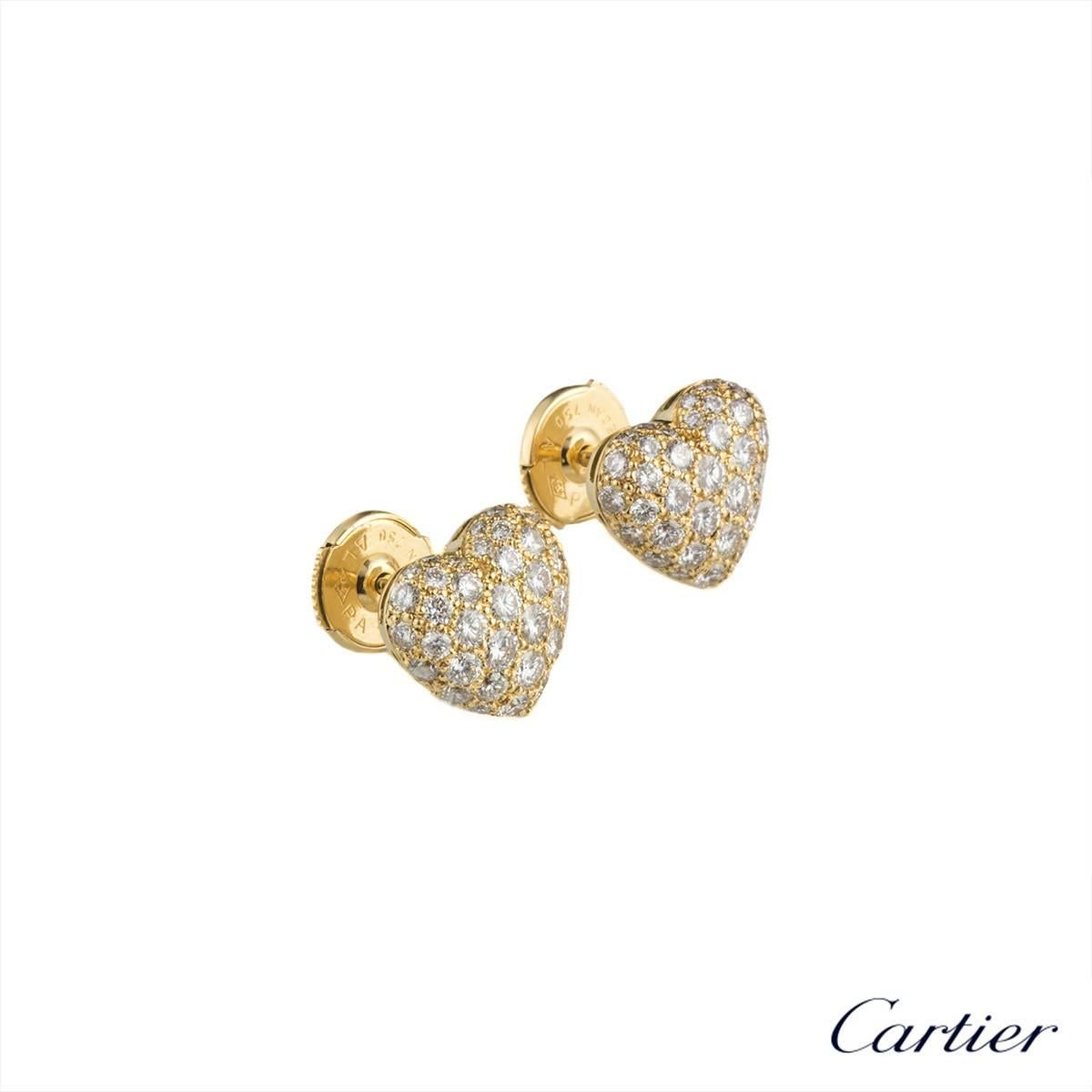 A pair of 18k yellow gold heart shape earrings. Each earring is set with 35 round brilliant cut diamonds totalling approximately 1.50ct. The earrings measure 1cmx cm and feature post and alpha back fittings, with a gross weight of 4.02 grams. 

The