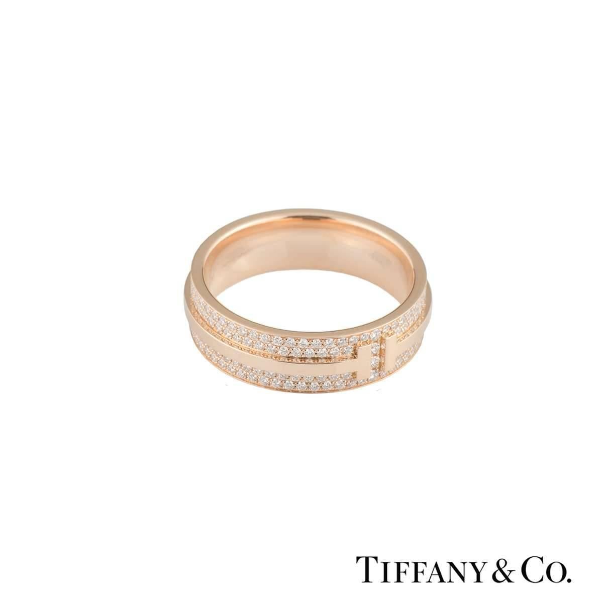 An 18k rose gold T Two ring by Tiffany & Co. The ring features a polished double T motif to the front and has a diamond set boarder. The pave set round brilliant cut diamonds total 0.57ct, are G colour and VS in clarity. The 6mm ring is a US size 6