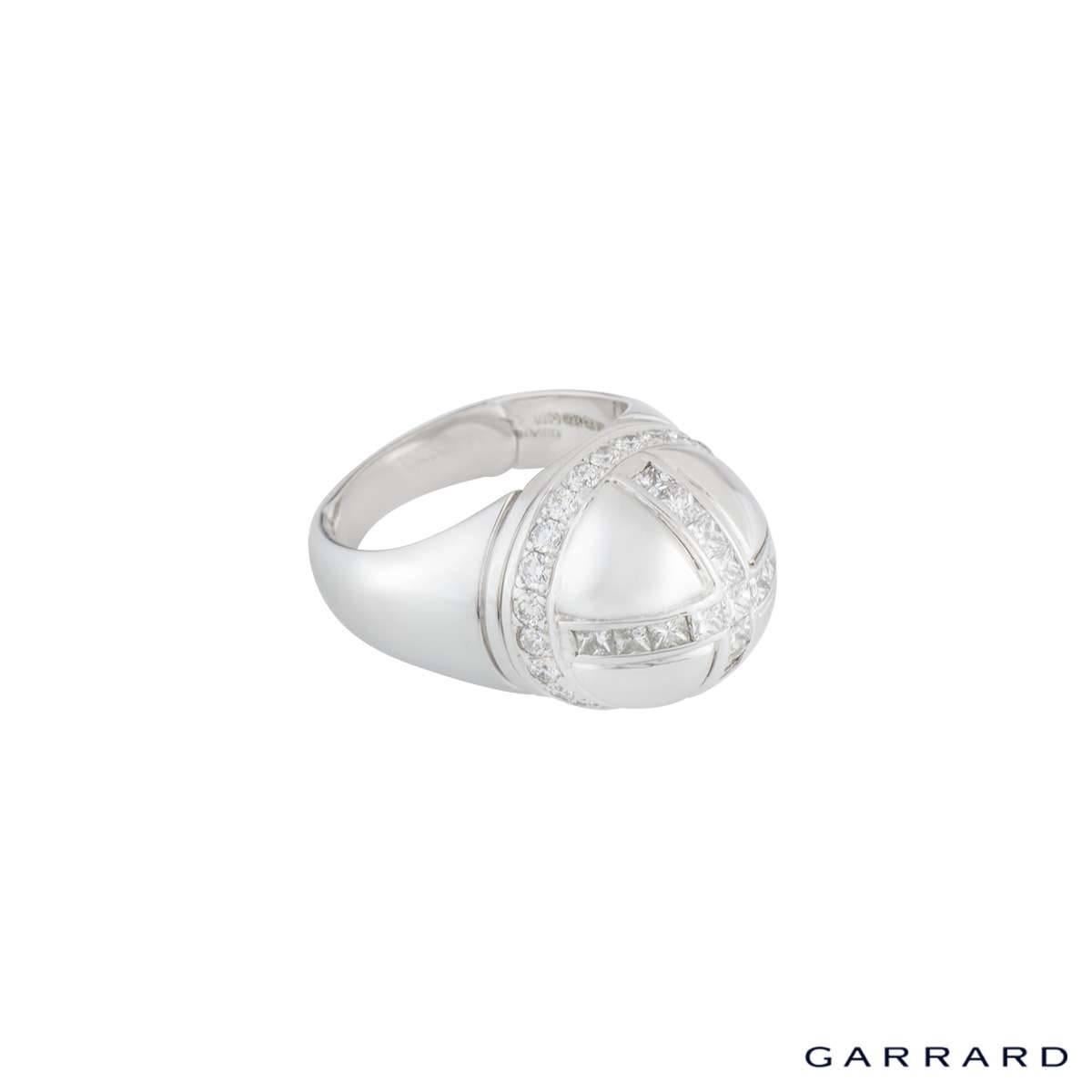 A unique 18k white gold diamond ring from Garrard. The dome shaped ring is set with princess cut diamonds on the top making a cross and around the sides are round brilliant cut diamonds making the ring a crown style totalling approximately 1.07ct.