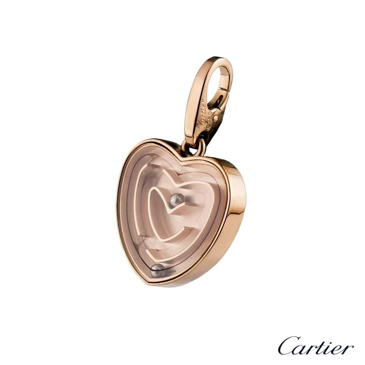 A stylish 18k rose gold Cartier heart maze pendant. The pendant comprises of a heart motif with a maze cased behind a pane of glass. Within the maze are 2 ball bearings freely moving throughout the maze. The pendant measures 17mm in height and 18mm