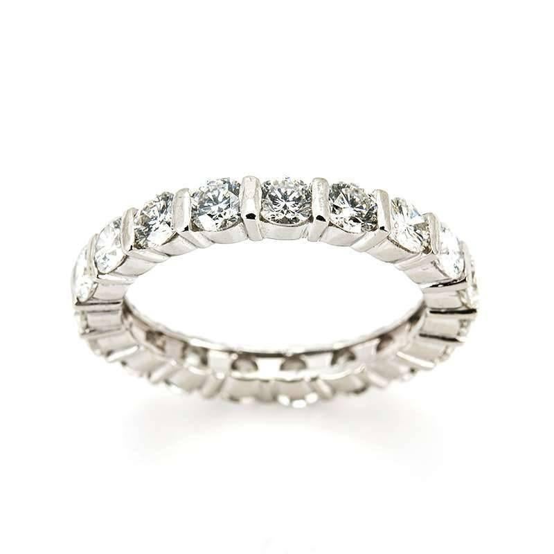 An elegant 18k white gold diamond set full eternity ring. The ring is set with 18 round brilliant cut diamonds each individually set within a four claw setting totalling approximately 1.90ct, G in colour and SI in clarity. The ring measures 3mm in