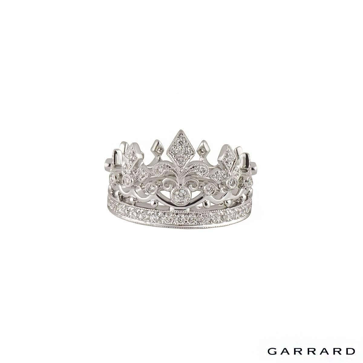A unique and beautiful 18k white gold Garrard diamond ring. The ring comprises of a princess crown motif with pave set round brilliant diamonds throughout the ring. There are a total of 68 diamonds through the ring and has an approximate weight of