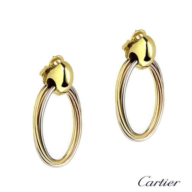 A large pair of 18k three colour gold Trinity de Cartier earrings c.1993. Each earring is made up of three intertwined 18k rose, white and yellow gold hoops, all linked through an 18k yellow gold surmount. The earrings measure approximately 4cm in