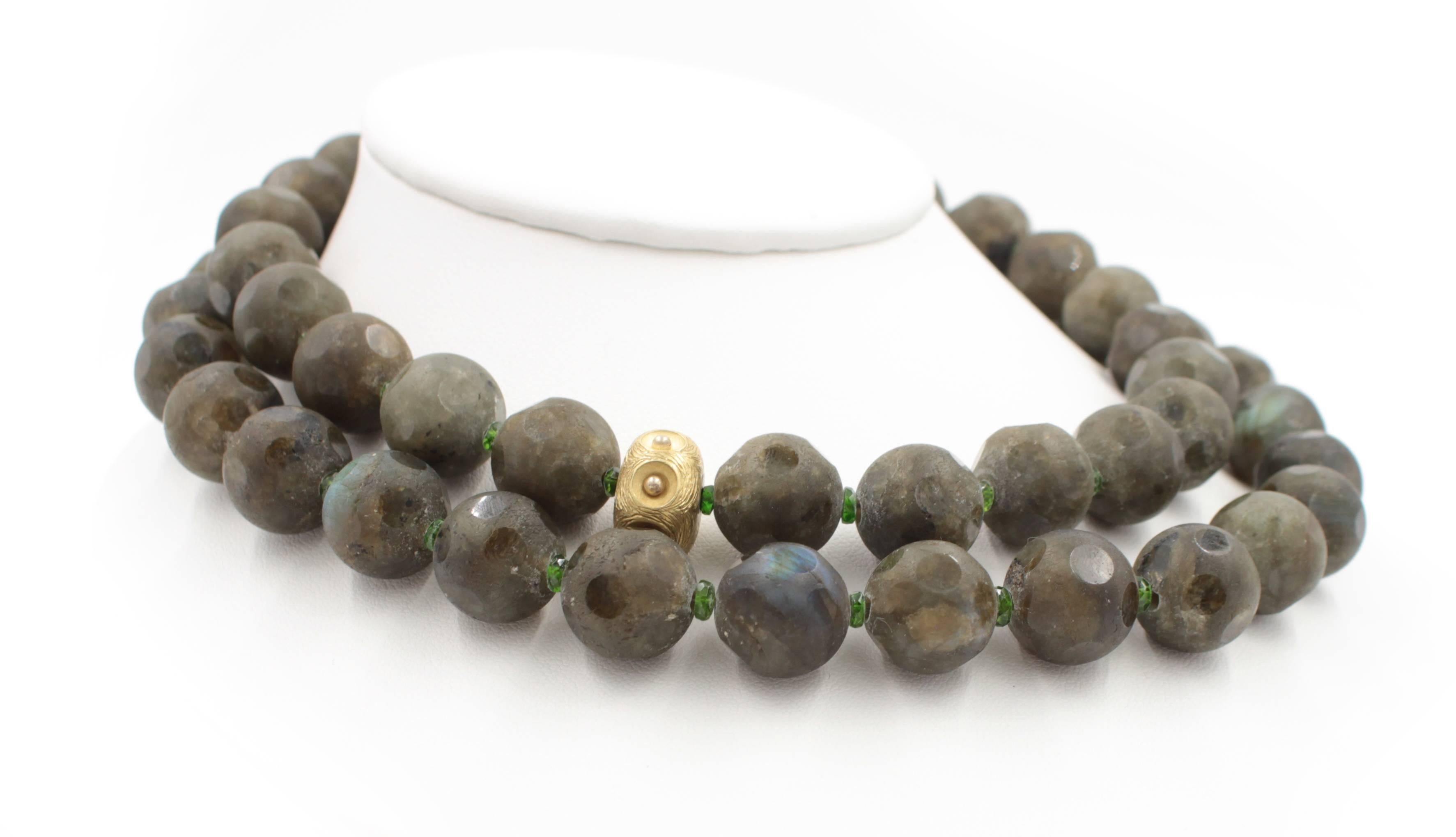 This elegant double strand necklace is made of specially cut gem quality labradorite beads. Each matte finish bead has a spattering of high polished circular shaped windows into the stone. This enhances the stone stunning iridescence. Between each