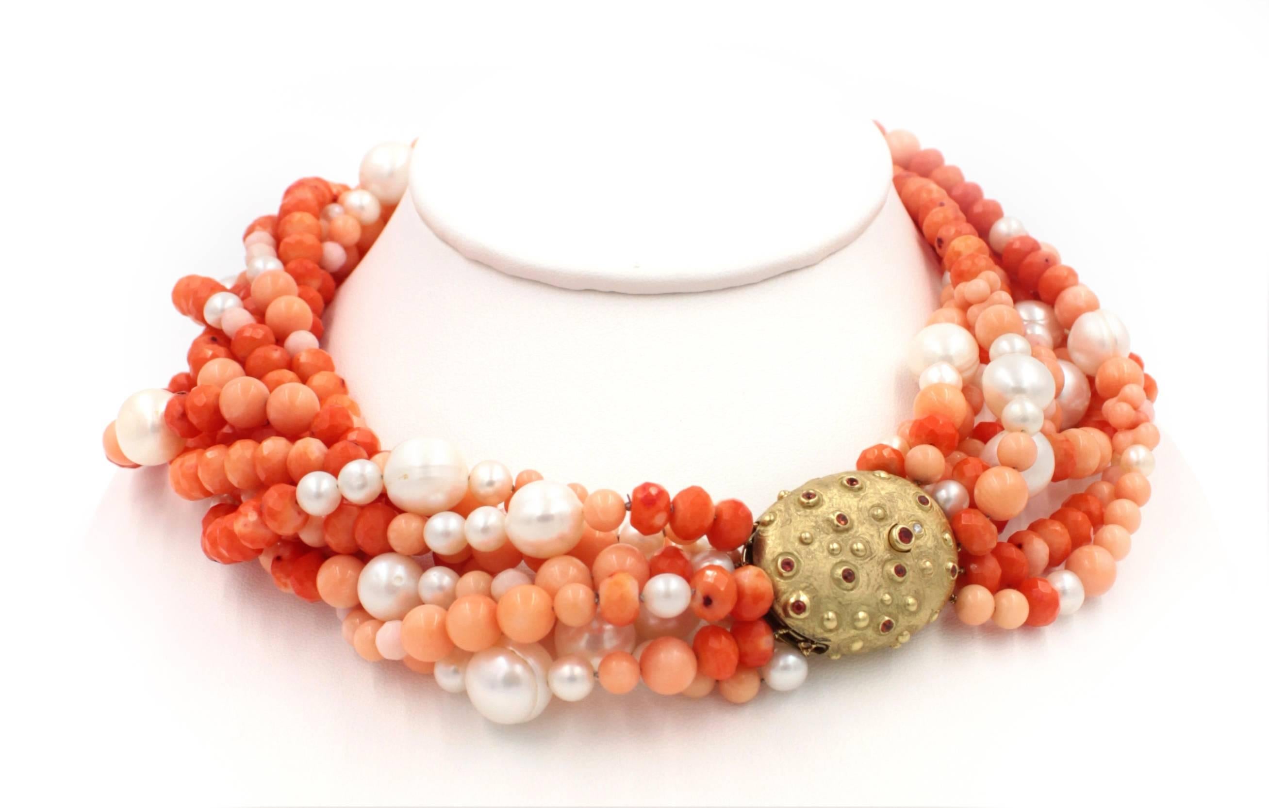 This 8 strand pearl and coral necklace is set with a wonderfully hand crafted 18k gold clasp set with 1.72ct orange sapphires. This clasp is so beautiful it is often worn as a center piece or just to the side of center. 