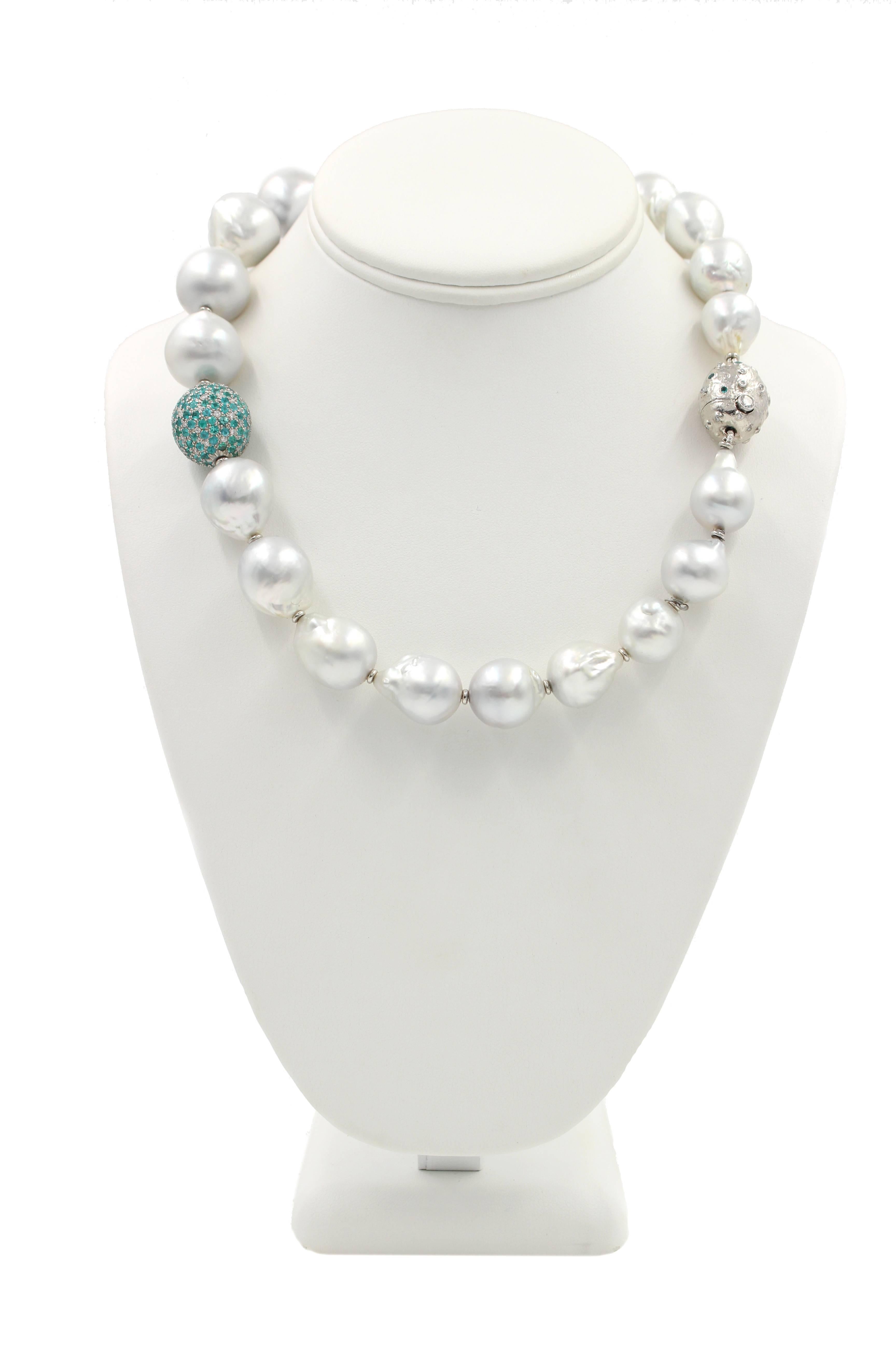 The Spectacular Necklace features South Sea Pearls strung with a Paraiba Tourmaline and diamond pave` set bead. The piece combines the classic look and feel of the strand of peals with the added color and design of the bright Paraiba Tourmaline and