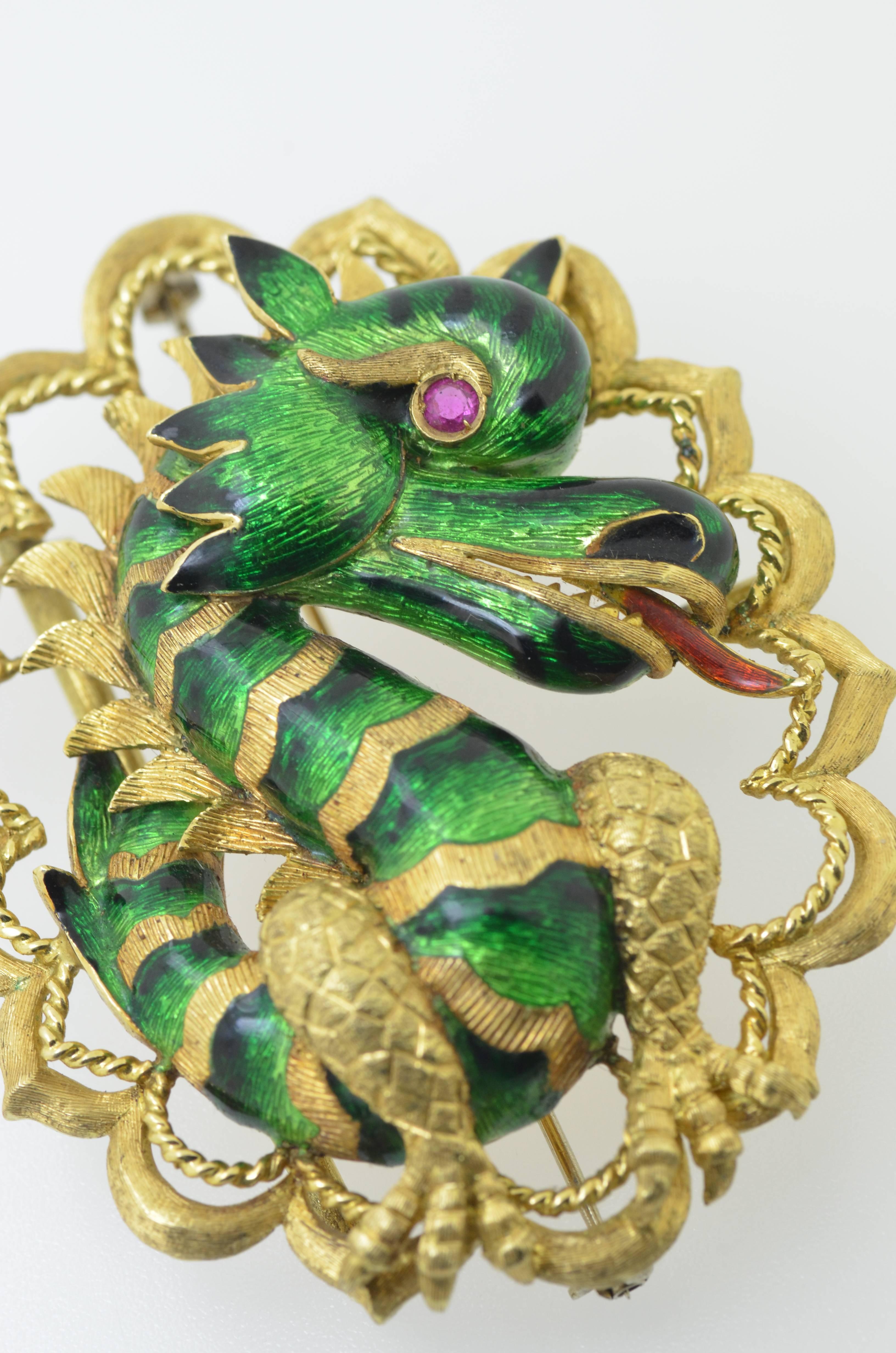 Large 18 karat yellow gold ruby and enamel dragon brooch with 18 karat yellow gold safet chain.