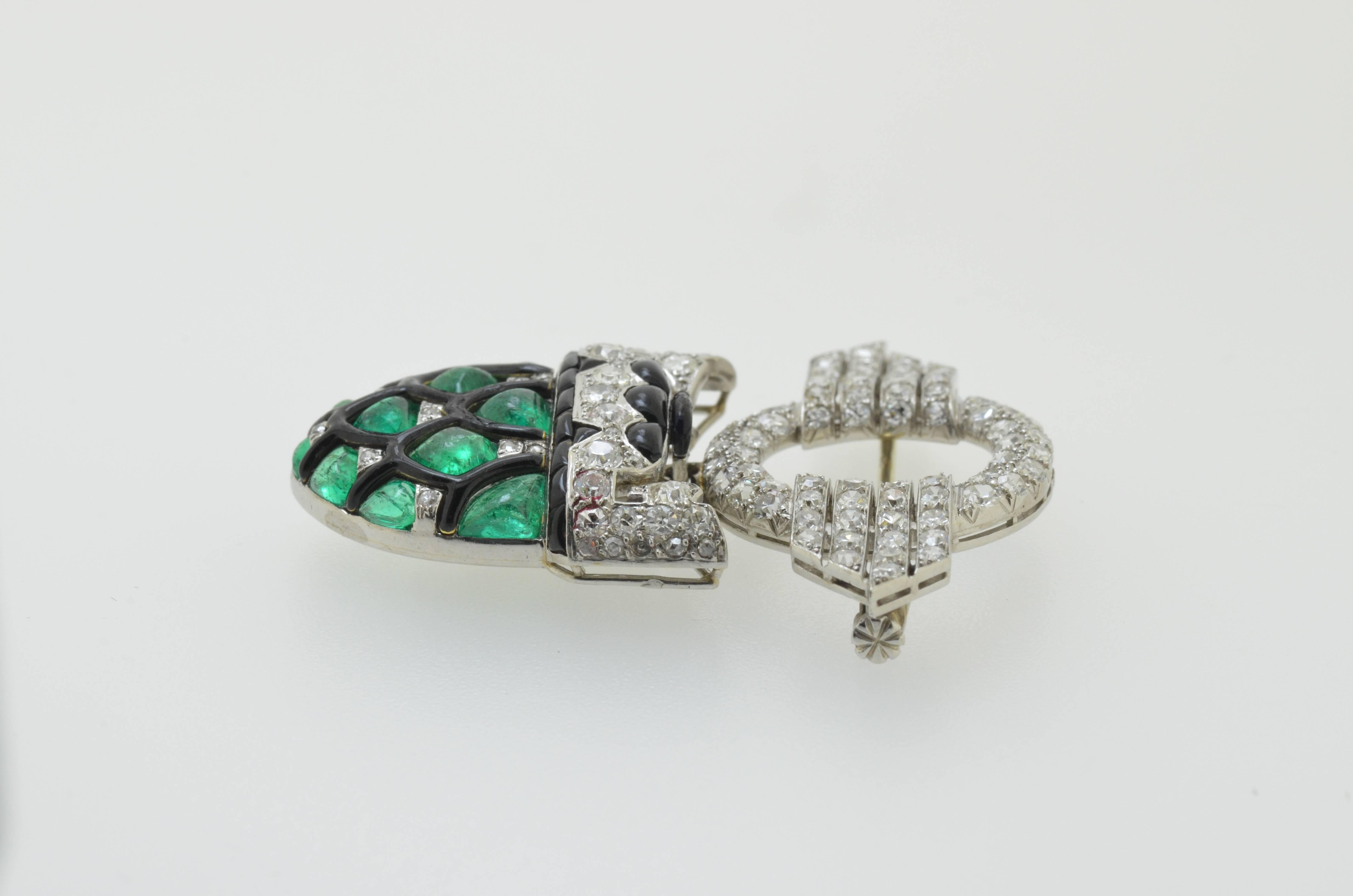 Original art deco diamond and emerald brooch set in with black enemal mounted in 15 karat white gold and platinum 