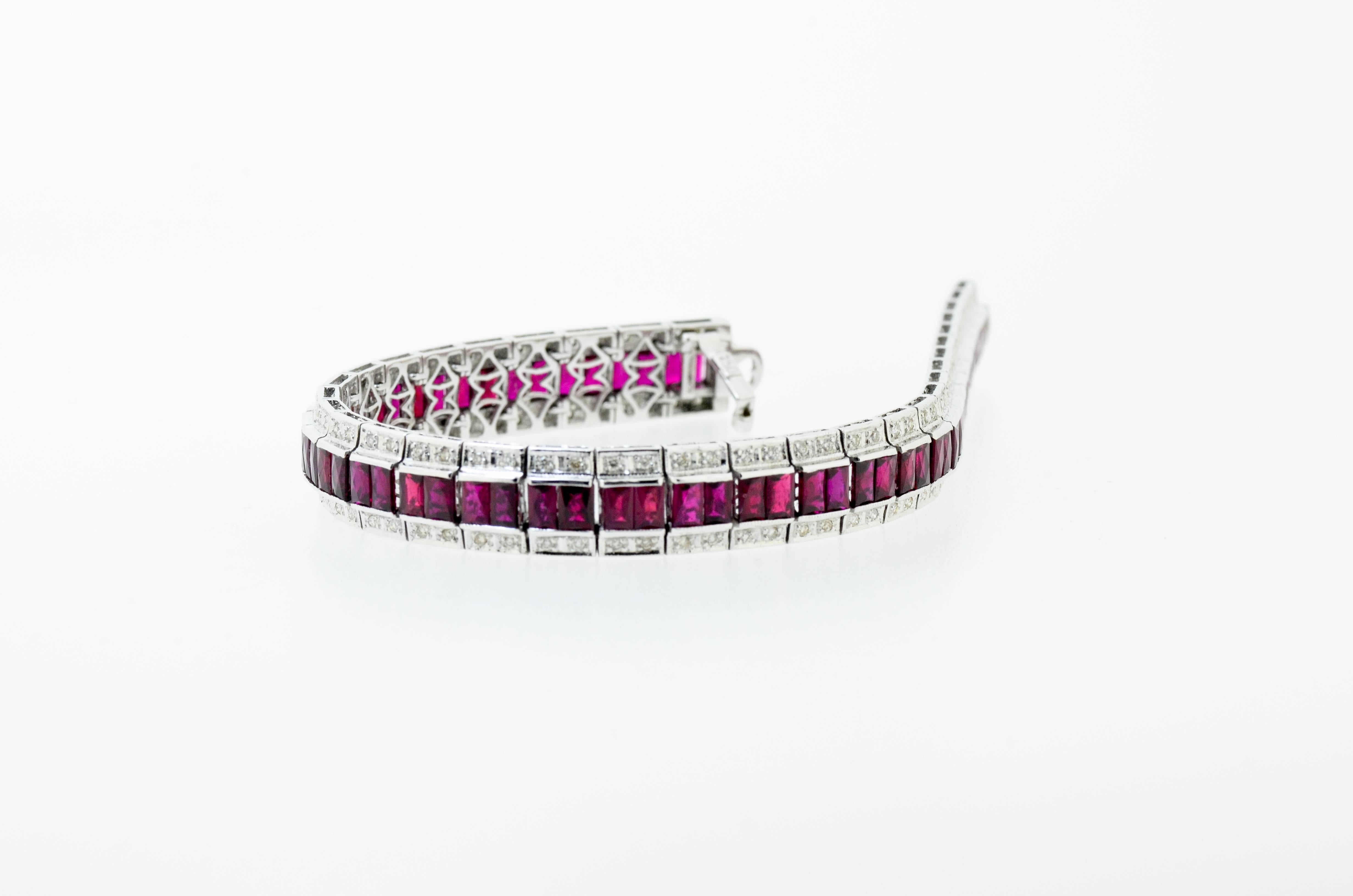 Stunning ruby and diamond bracelet set with over 10 carats of baguette cut ruby and 0.830 carat of clean white brilliant cut diamonds set in 18 karat white gold.

