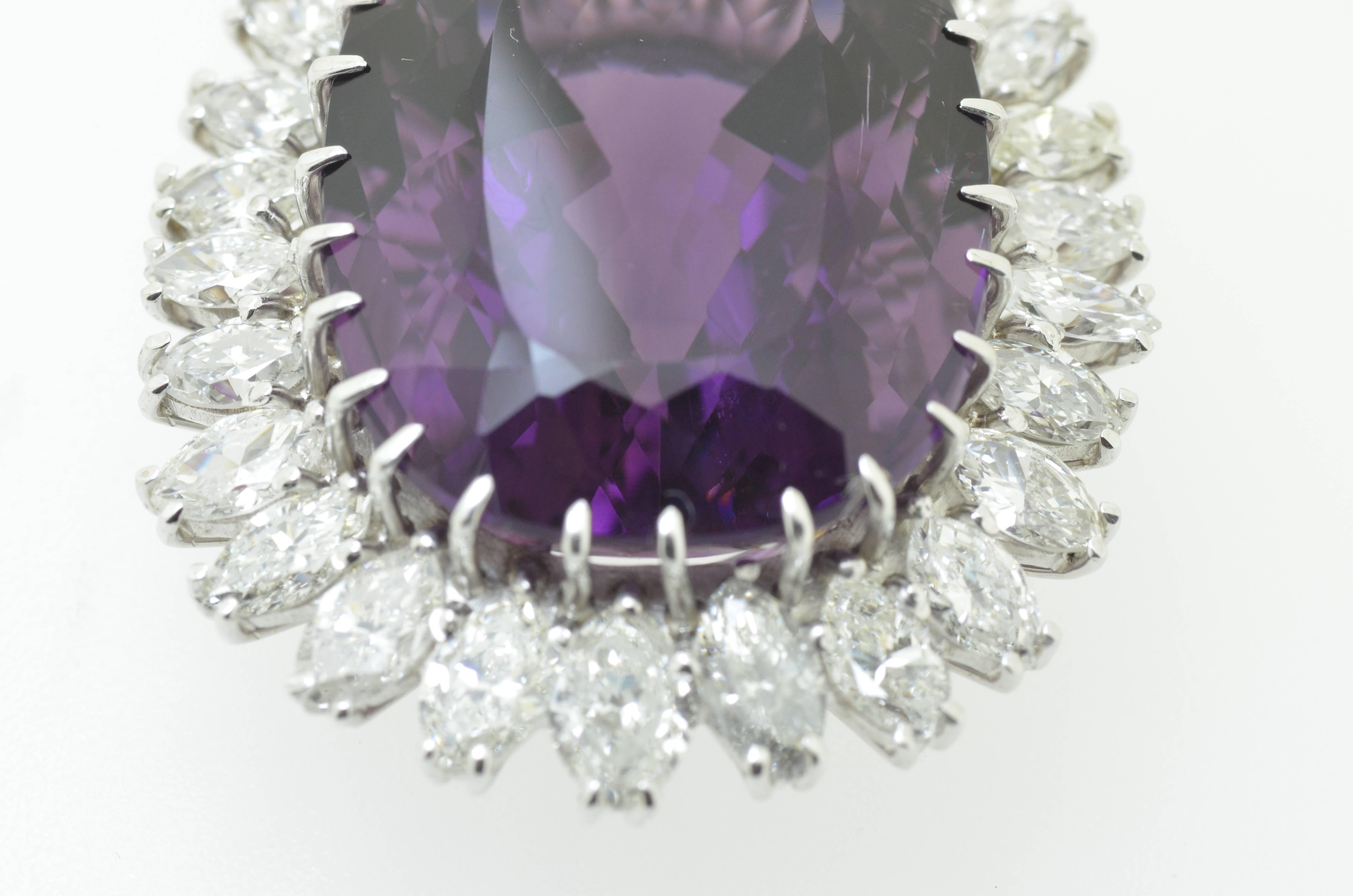 Beautiful pendant featuring a rich violet  russian amethyst approximately 45 carats in total set with 29 graduating clean white marquise diamonds totaling approximately 5.8 carats in 18K white gold.

Makers mark: M.J