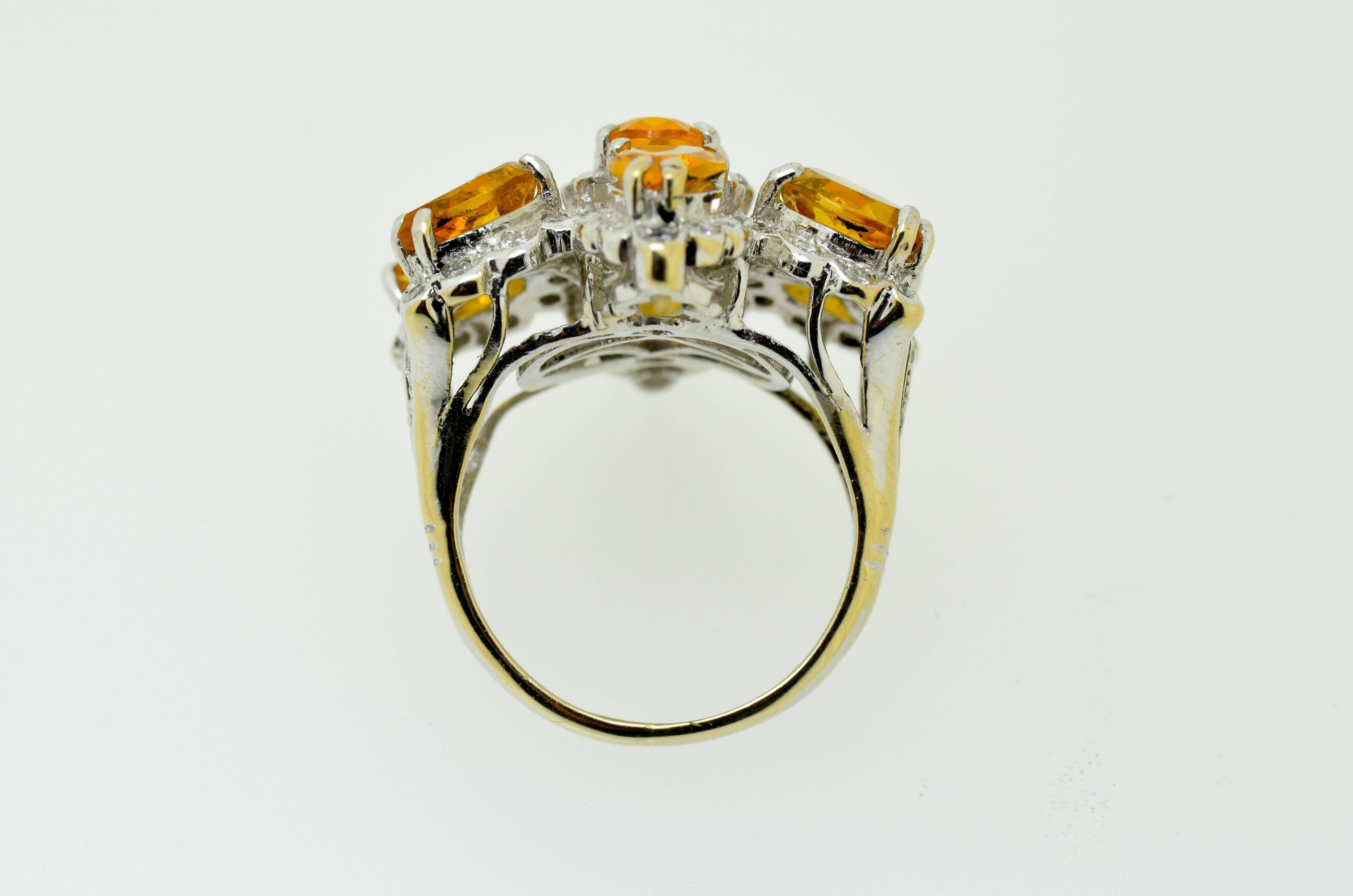 18 Karat gold citrine and diamond ring set with 7 oval and pear shaped citrines and 76 clean white brilliant cut diamonds

SIZE: K 