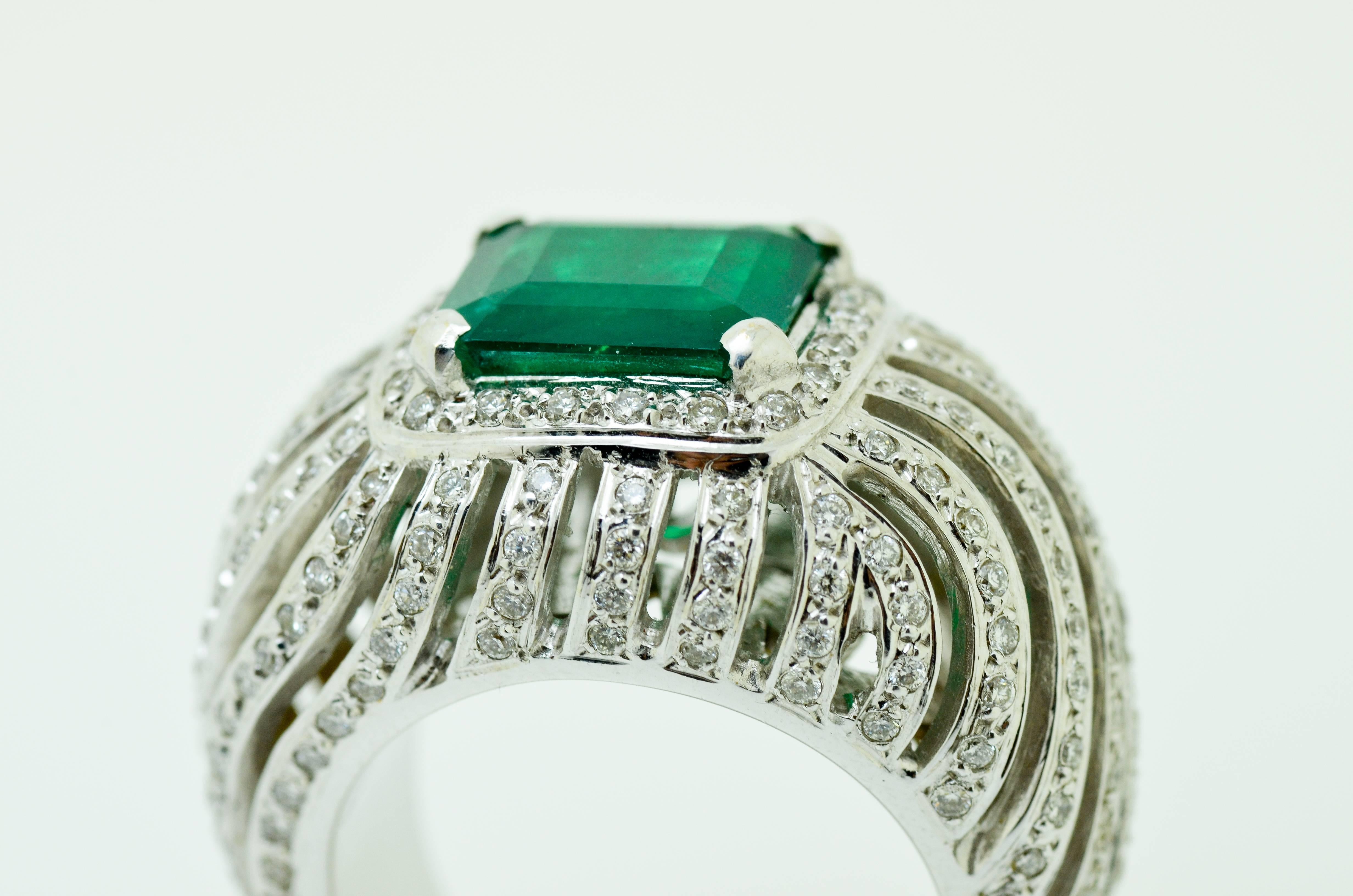 Stylish 18 karat white gold, diamond and emerald ring consisting a natural rectangle emerald centre stone and over 1 carat of clean white brilliant cut stones on mount. 

Accompanied by GEMA CYT certiciation:

Emerald: 6,85 Carats
Diamonds: