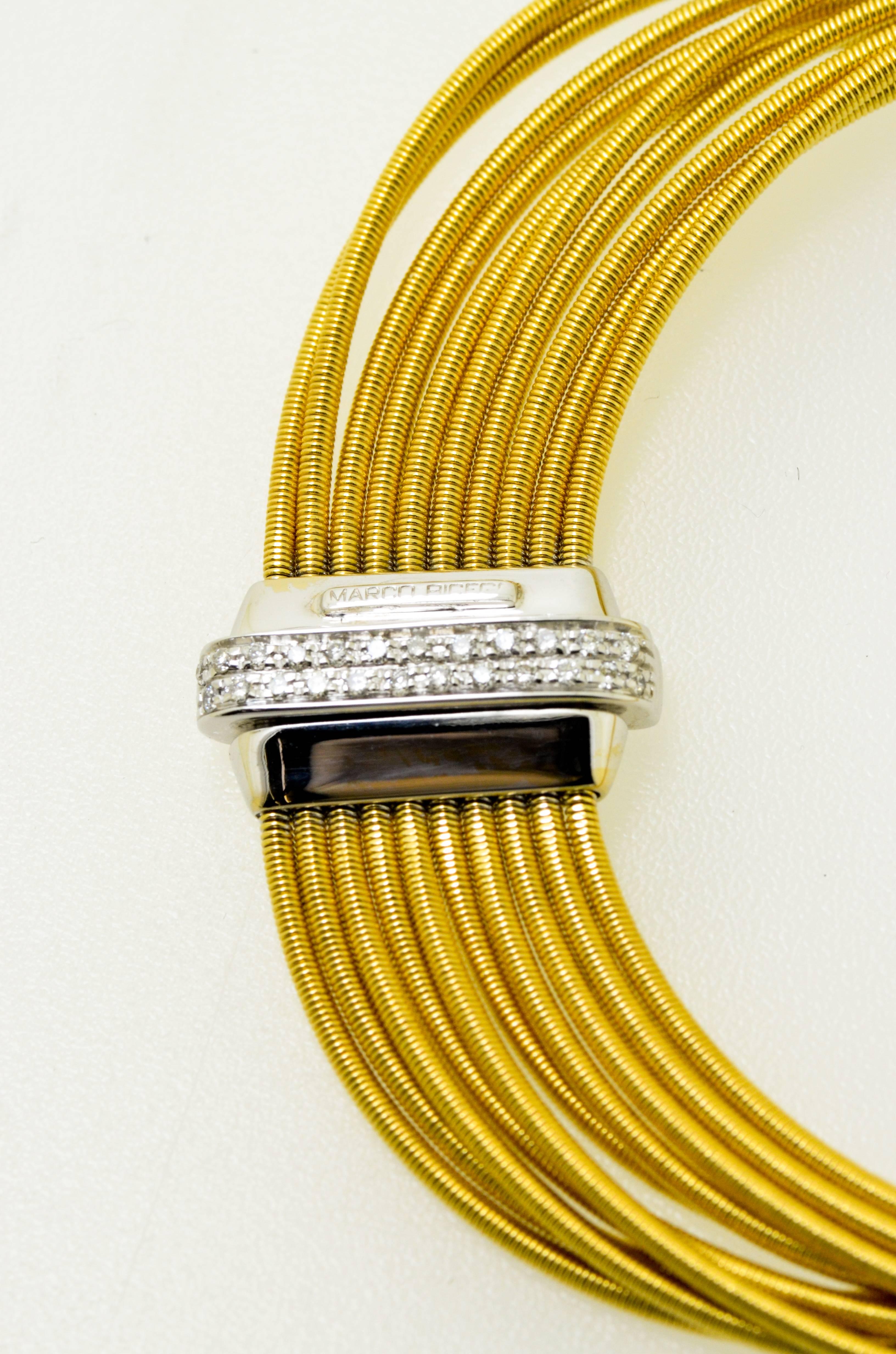 Distinctive and luxurious, the signature texture of this gold bracelet is the result of fine gold thread meticulously wrapped around a gold core.

18K yellow gold 10 strand bracelet with diamond clasp from the Cairo Collection from italation