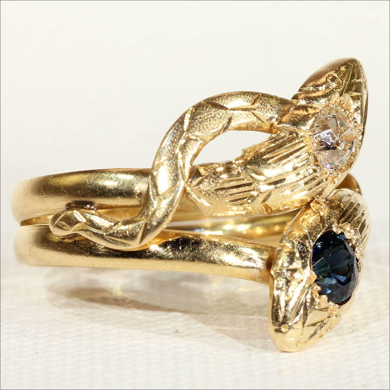 This fabulous antique dual snake ring was handcrafted in France around 1890. It was made in 18 karat gold and features a deep blue sapphire and a glittering white diamond. The round faceted sapphire, found on one of snake’s heads, measures 4.9 x