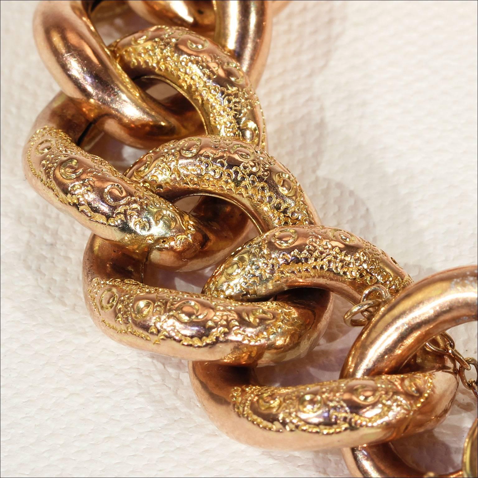 This gold link chain bracelet was handcrafted in England in about 1885. The heart shaped lock is engraved with floral details while the links themselves are also engraved, with intricate and beautiful designs. The maker put a lot of thought into