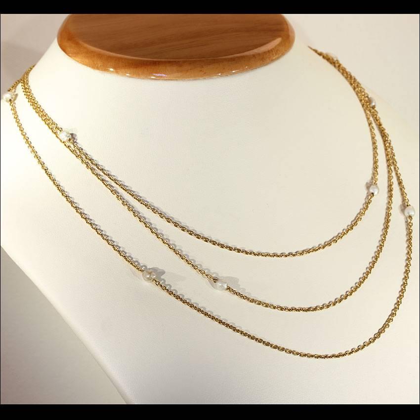 This antique Victorian link chain was handcrafted in 14 karat gold. It features 9 gray naturals pearls that range in diameter from 3.3 mm to 7 mm. There are three total chains on this one of a kind necklace. The shortest chain measures 18 ¼ inches