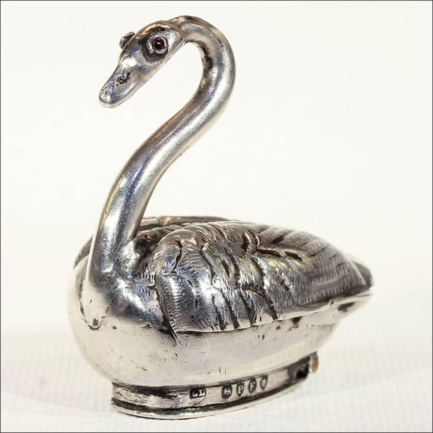 This antique Dutch swan snuffbox was handcrafted around 1880. It was made in sterling silver and is shaped like a graceful swan. It opens from the bottom and reveals a cavernous space that someone in the Victorian age would have used to store snuff.