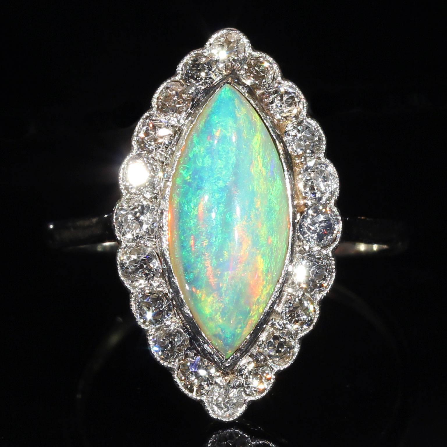This fantastic Opal has a magnificent play of color and is cut in a tantalizing cabochon marquise. It’s blues and greens, oranges, yellows and reds can be seen dancing and glimmering in any light, from any angle. The luminous gem is set within a