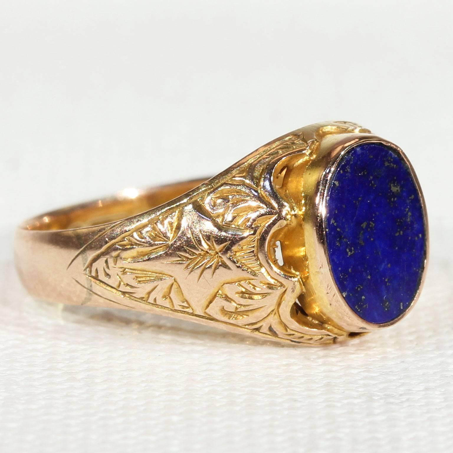 This wonderful antique Victorian lapis and gold ring was handcrafted in Chester, England, in 1896. A mesmerizing oval lapis stone is belcher set in the center of this ring, it measures 8.4 x 6.8 mm. The shoulders are smothered in beautiful floral