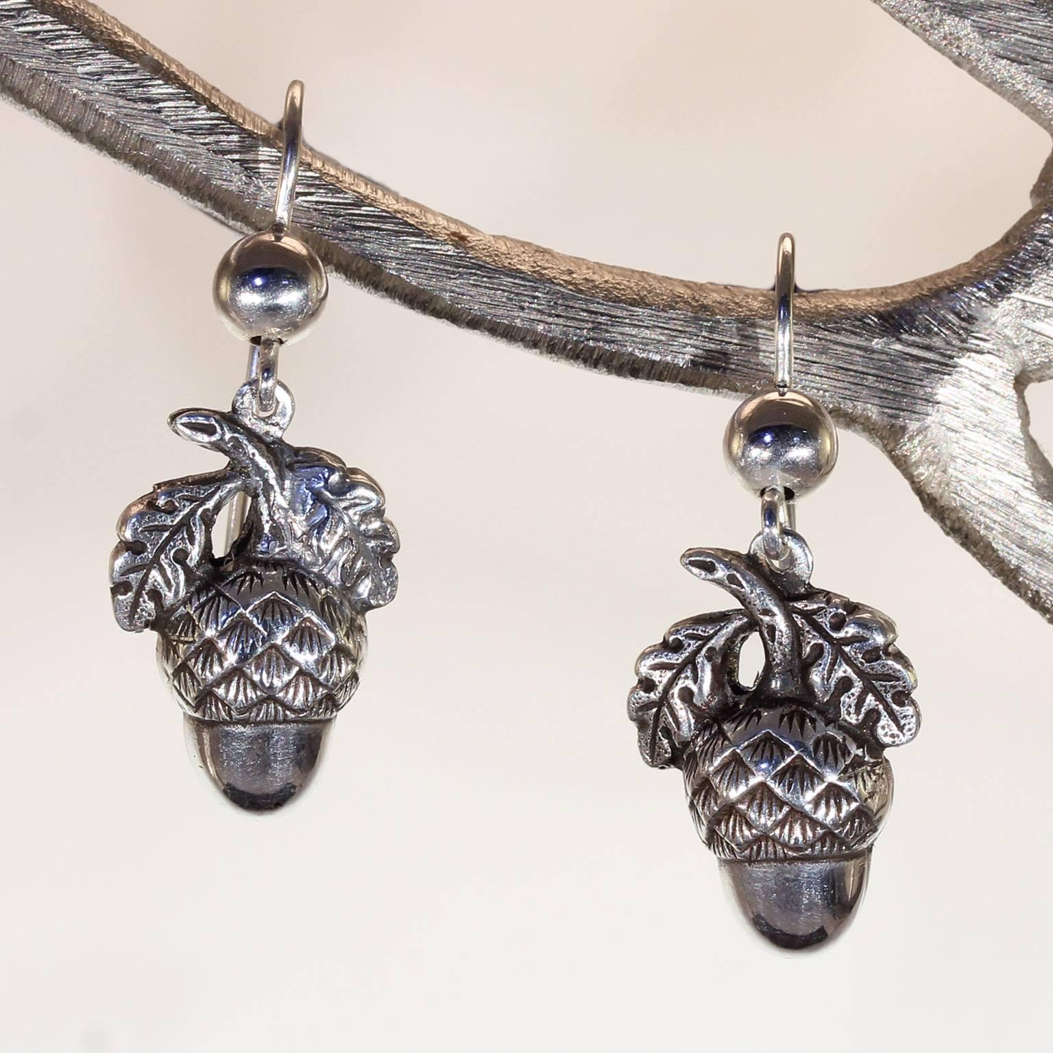 These adorable antique late Victorian silver acorn earrings were handcrafted around the year 1900. They are lovely nature-inspired earrings that represent life, fertility, and immortality. Acorns are the seed of the sturdy and tall oak tree, a tree