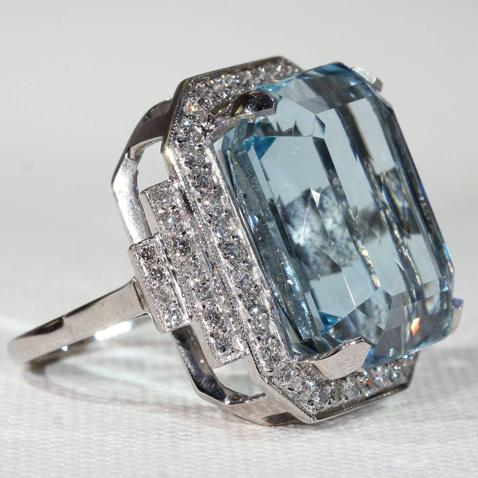 This vintage ring was handcrafted around the 1950s. It’s a cocktail ring at its finest made in 18 karat white gold. A large rectangular light blue aquamarine is set at the center, measuring 20 x 16.3 x 11.3 for an approximate weight of 26 carats!