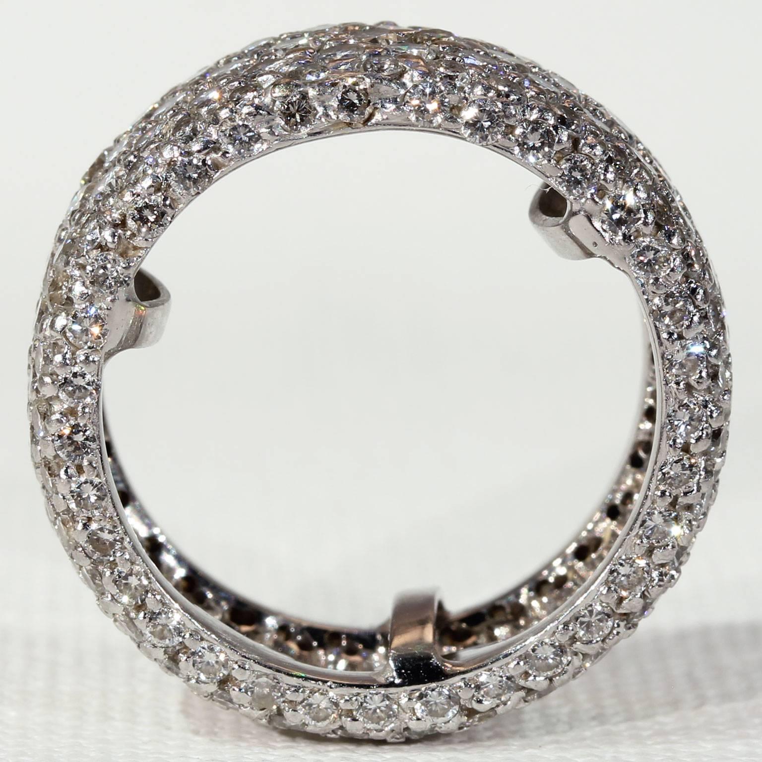 This vintage platinum diamond eternity band features seven rows of brilliant cut diamonds, for a total of 231 round sparkling stones. Altogether the diamonds weigh approximately 4.3 carats. This ring fits like a size 7.5 and has three sizers inside